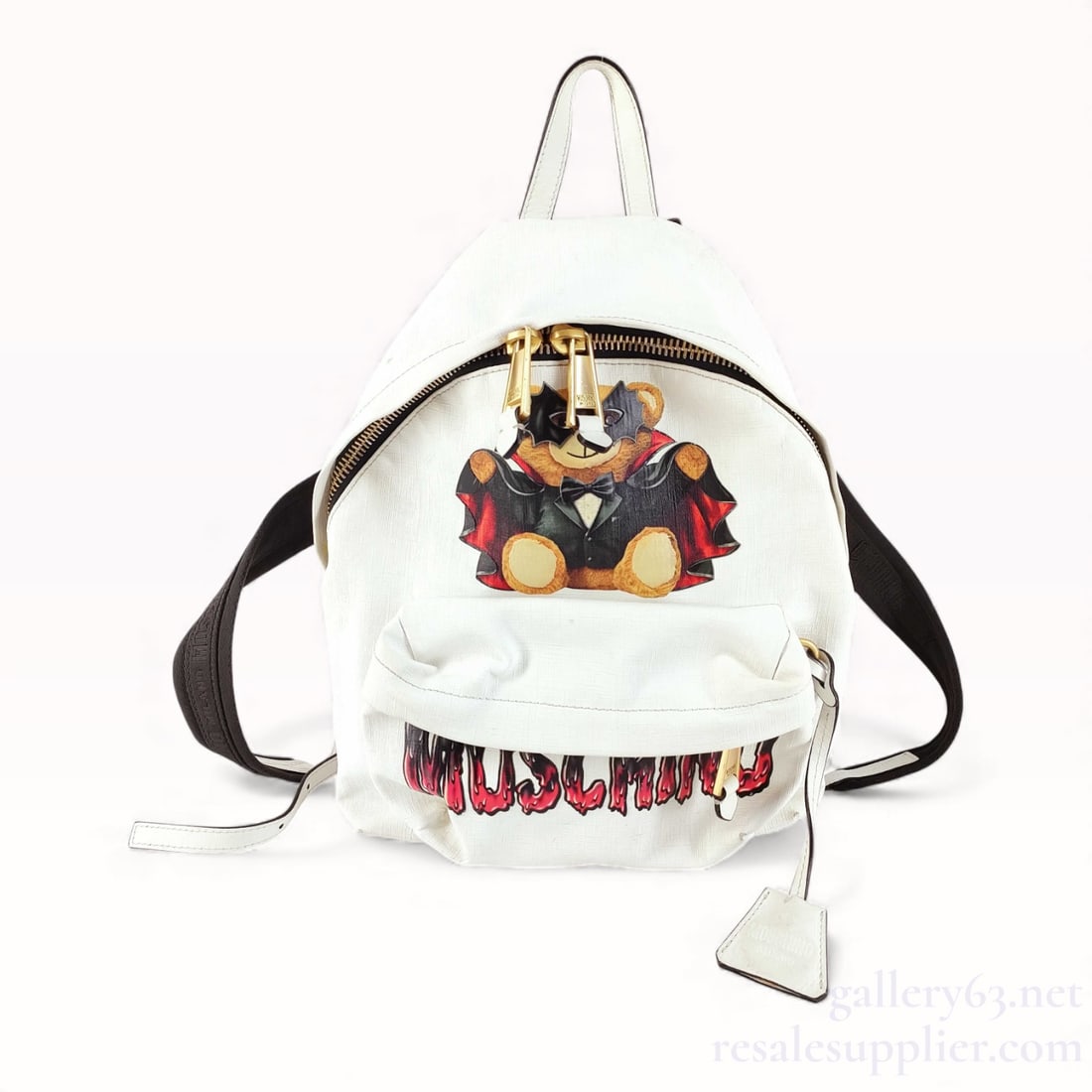 Moschino Leather White Backpack Teddy Bear: Very good condition. Authentic Moschino White Backpack Description: Backpack featuring white leather with a front graphic of the Moschino teddy bear dressed in a costume. Designed with a front z