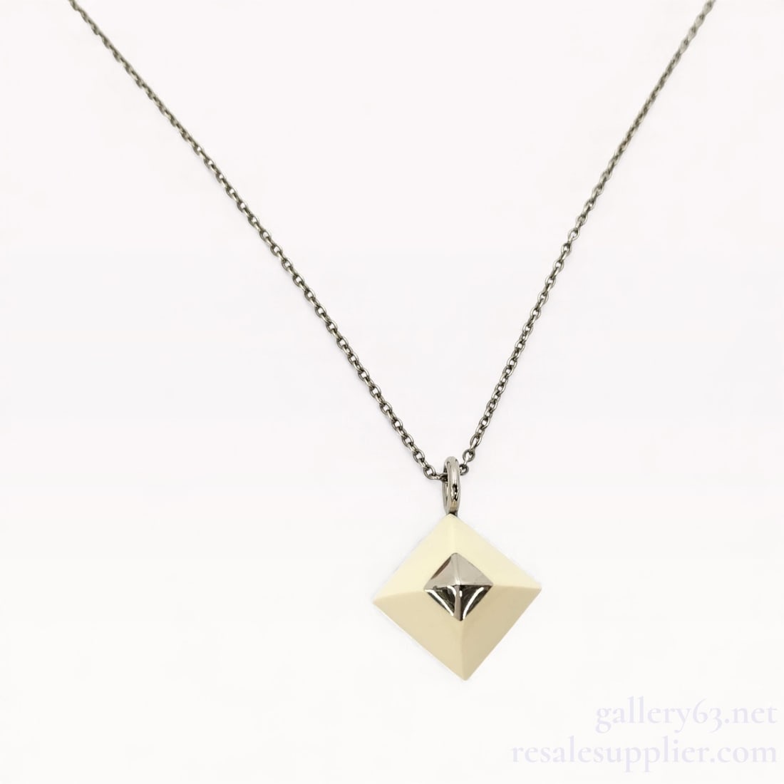 Hermès Cupid on Chain Necklace 16": Excellent condition. Authentic Hermès Cupid on Chain Necklace. Necklace featuring a geometric square pendant with a raised pyramid form at the center. Pendant is suspended from a fine metal chain and