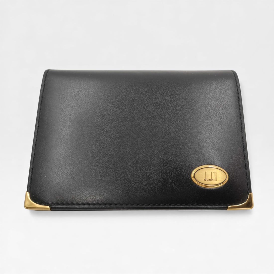 Dunhill Black Leather Bifold Business Card Case - excellent condition: Authentic Dunhill black leather bifold business card case with gold-tone metal corners and logo detail.