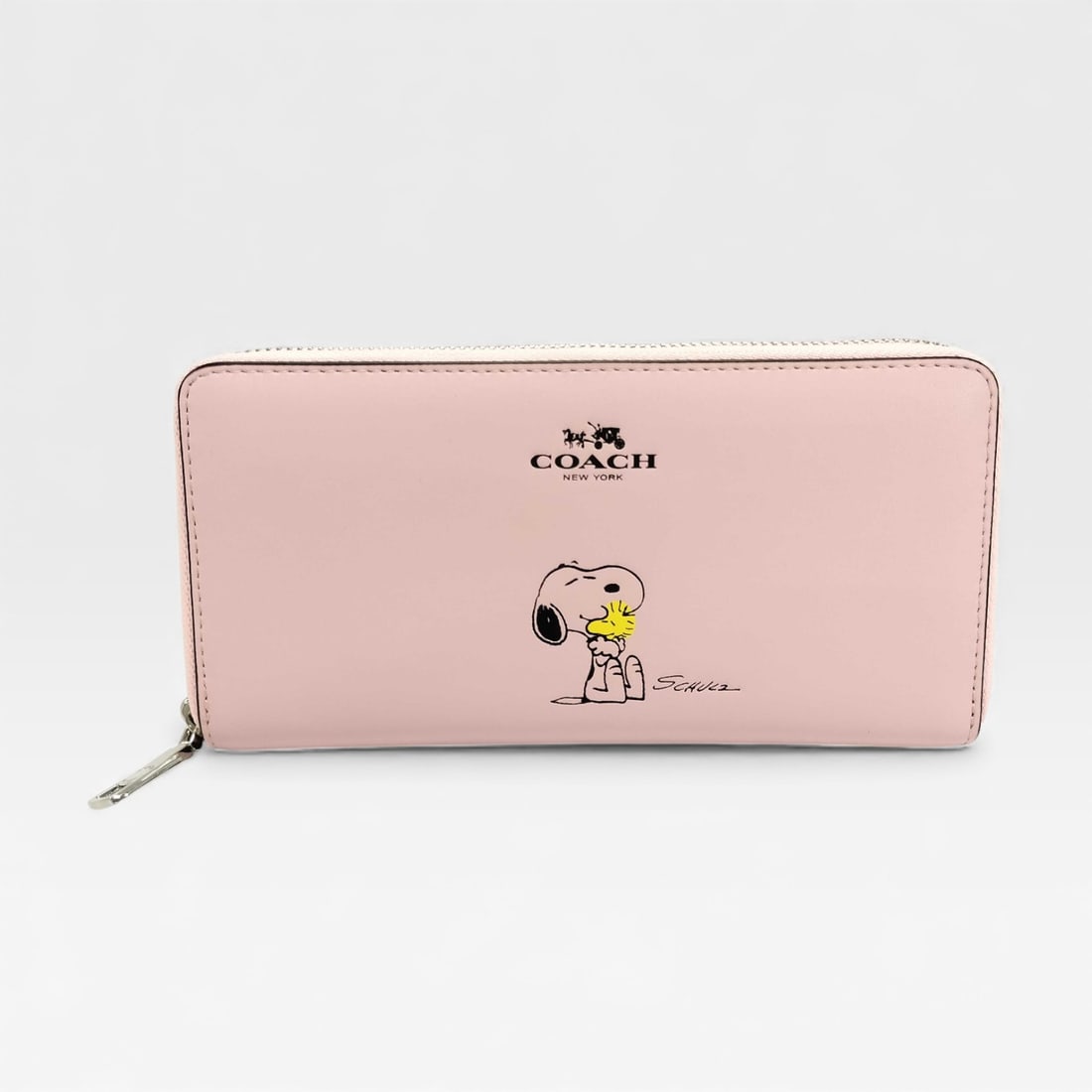 Coach x Peanuts Long Zip Around Wallet in Light Pink Leather - Excellent Condition: Authentic Coach x Peanuts Long Zip Around Wallet in light pink leather with a Snoopy and Woodstock print.