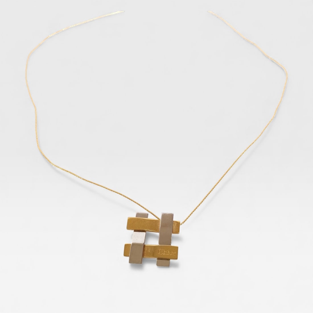 Chloé White and Yellow Gold EP Box Check Necklace: Made in France Chloé White and Yellow Gold EP Box Check Necklace.