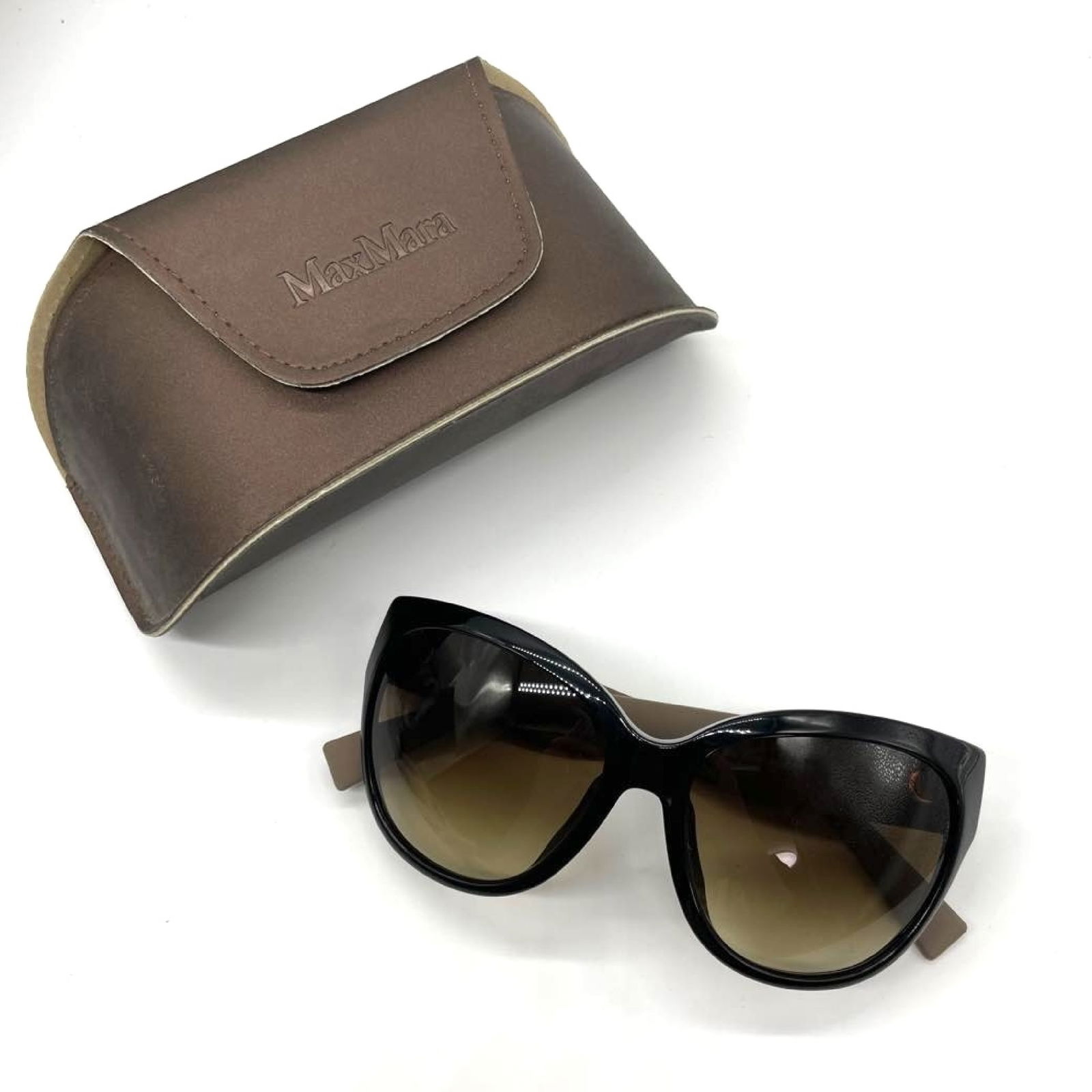 Max Mara MM0002 Black Gradient Lens Sunglasses with Case: Max Mara MM0002 sunglasses having an oversized rounded frame in glossy black acetate. Brown gradient lenses featuring darker tint at top fading lighter toward bottom. Wide temples in coordinating dark