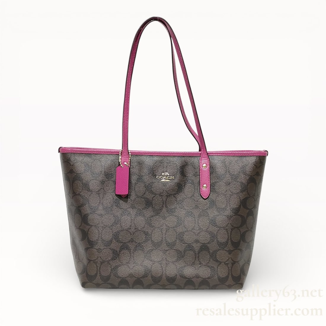 Coach Signature Canvas Tote Bag - Excellent Condition: Authentic Coach tote bag having signature coated canvas construction in brown with allover logo pattern. Trimmed with magenta leather at the top edge and shoulder straps. Dual flat shoulder straps set