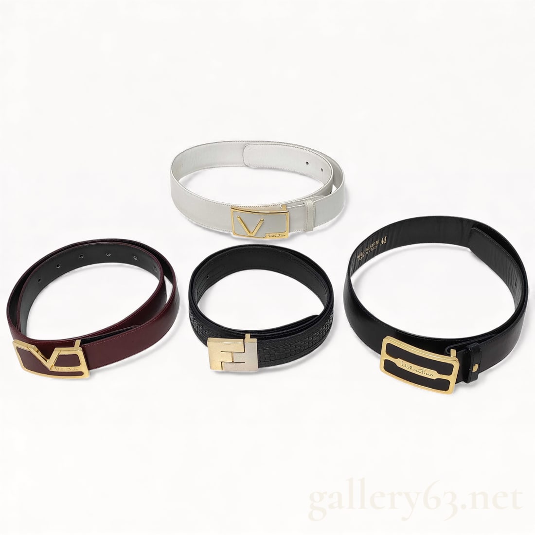 Designer Leather Belt Set of Four Featuring Fendi and Valentino: belt set consisting of four designer leather belts including examples by Fendi and Valentino. Belts presented in black, white, burgundy, and textured black leather. Each belt fitted with gold-tone log