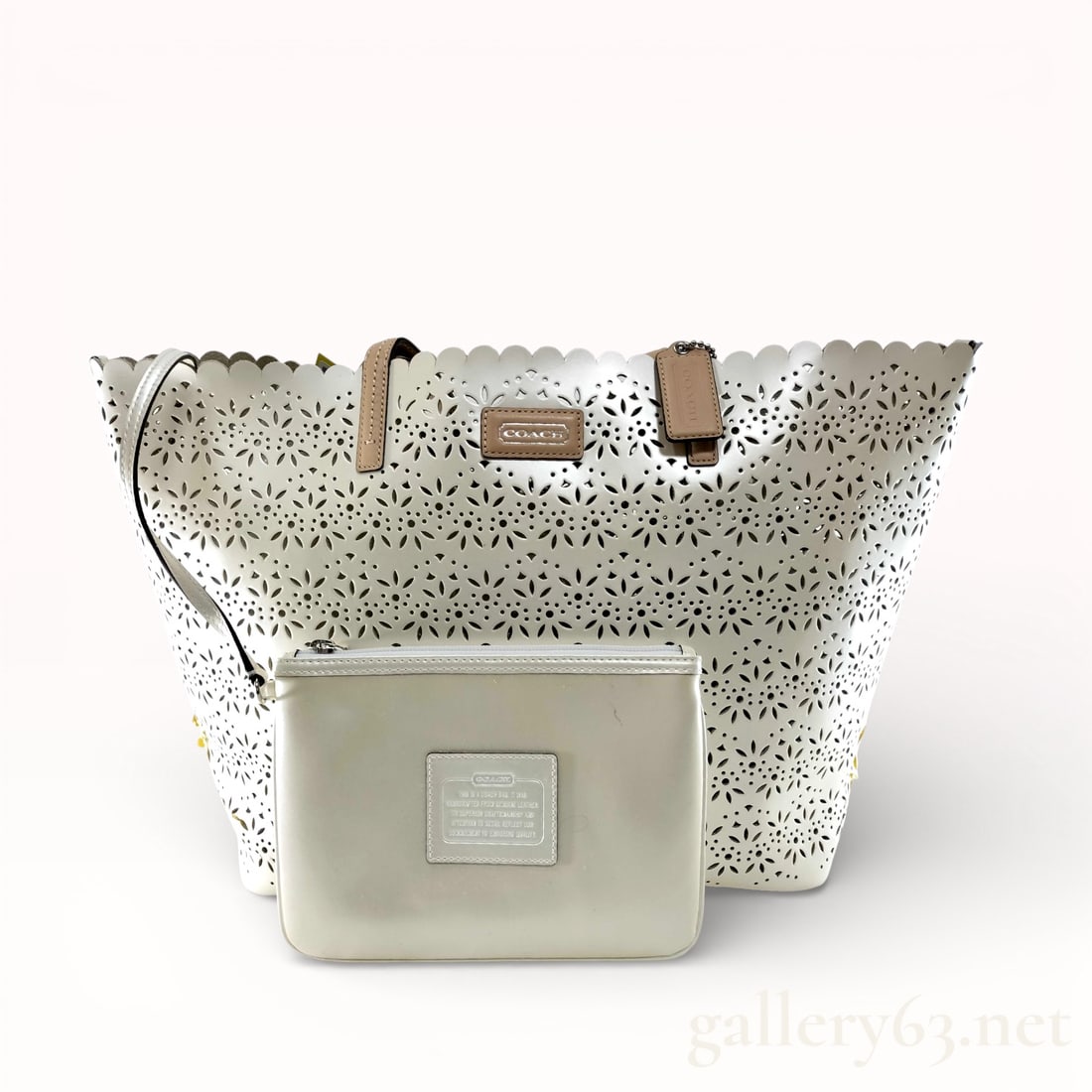 Coach Perforated Taylor White Leather Cutout with Pouch Tote Bag: Authentic Coach F27391 Taylor eyelet chalk leather tote bag with a matching pouch. Having white leather exterior with allover perforated cutout floral pattern. Tote featuring scalloped top edge, dual