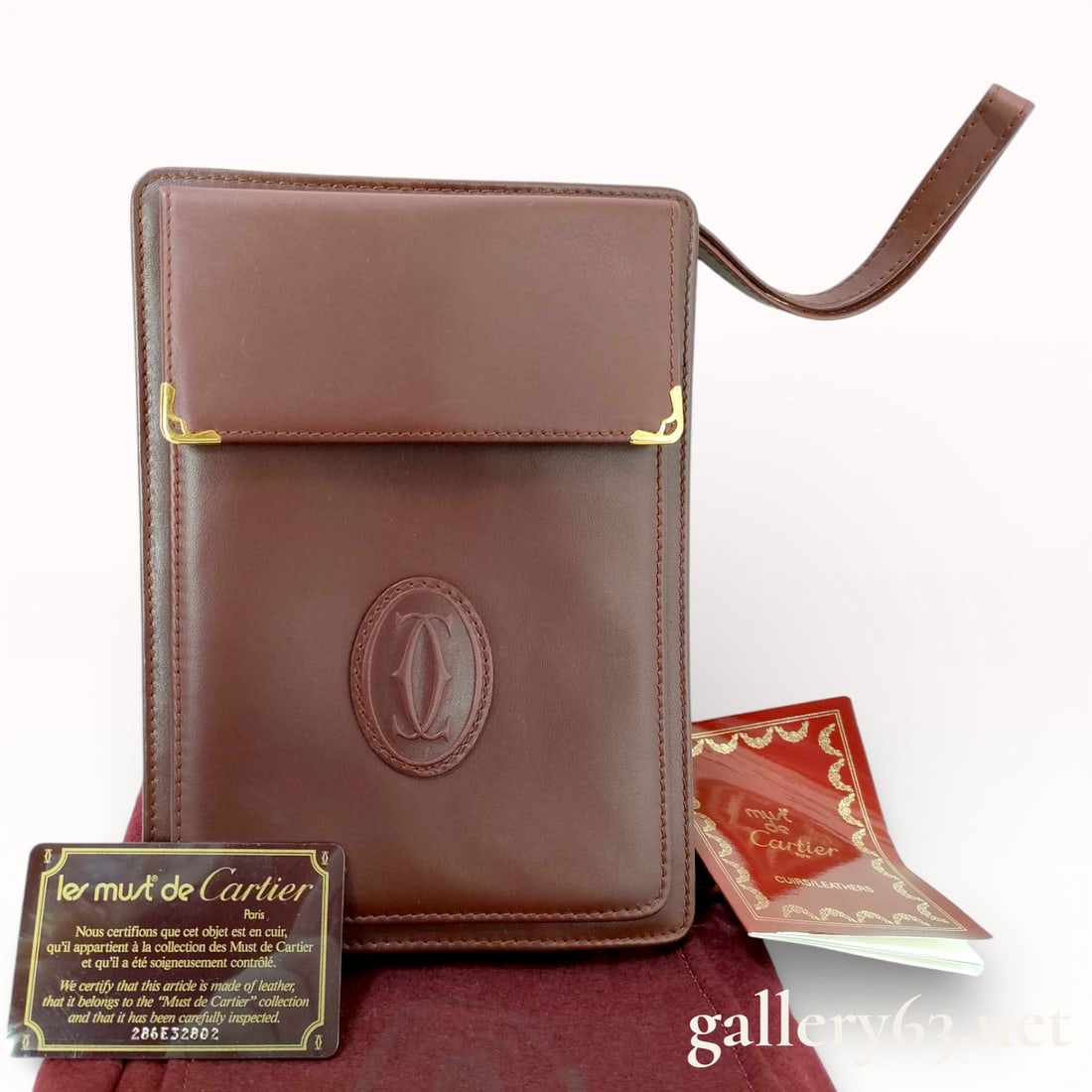 Vintage Cartier Bordeaux Calfskin Wristlet Clutch with Dust Jacket & COA: Authentic vintage Cartier Bordeaux reddish maroon leather wristlet clutch wallet with gold tone hardware. Comes with dust jacket and COA. 