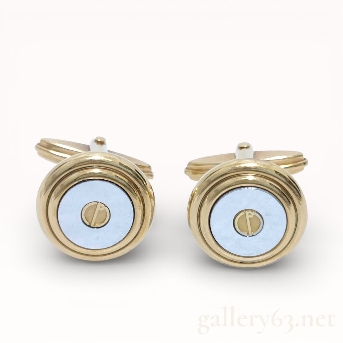 Dunhill Gold Tone Enamel Cufflinks with Light Blue Centers: Authentic Pair of Dunhill cufflinks having round gold tone settings with light blue enamel centers. Circular face design set with a central screw-head style motif. Fixed toggle backs in matching gold