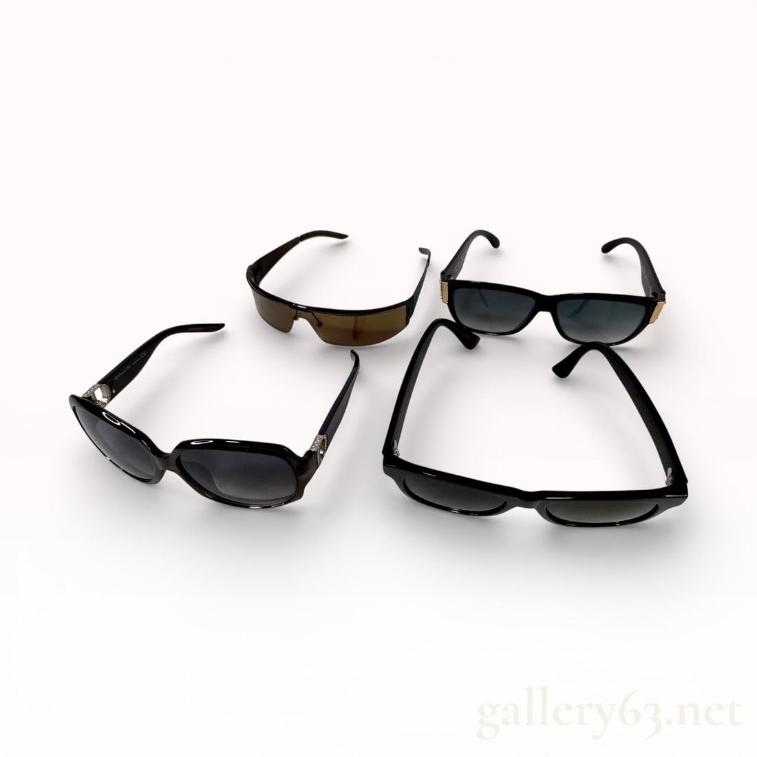 Designer Sunglasses Lot Including Dior, Gucci, And Calvin Klein: Group of four designer sunglasses including Dior model 19L9C, Gucci GG0044SA, Gucci GG1726, and Calvin Klein model 9263-3. Collection featuring black frames in assorted shapes and lens styles. Mixed c
