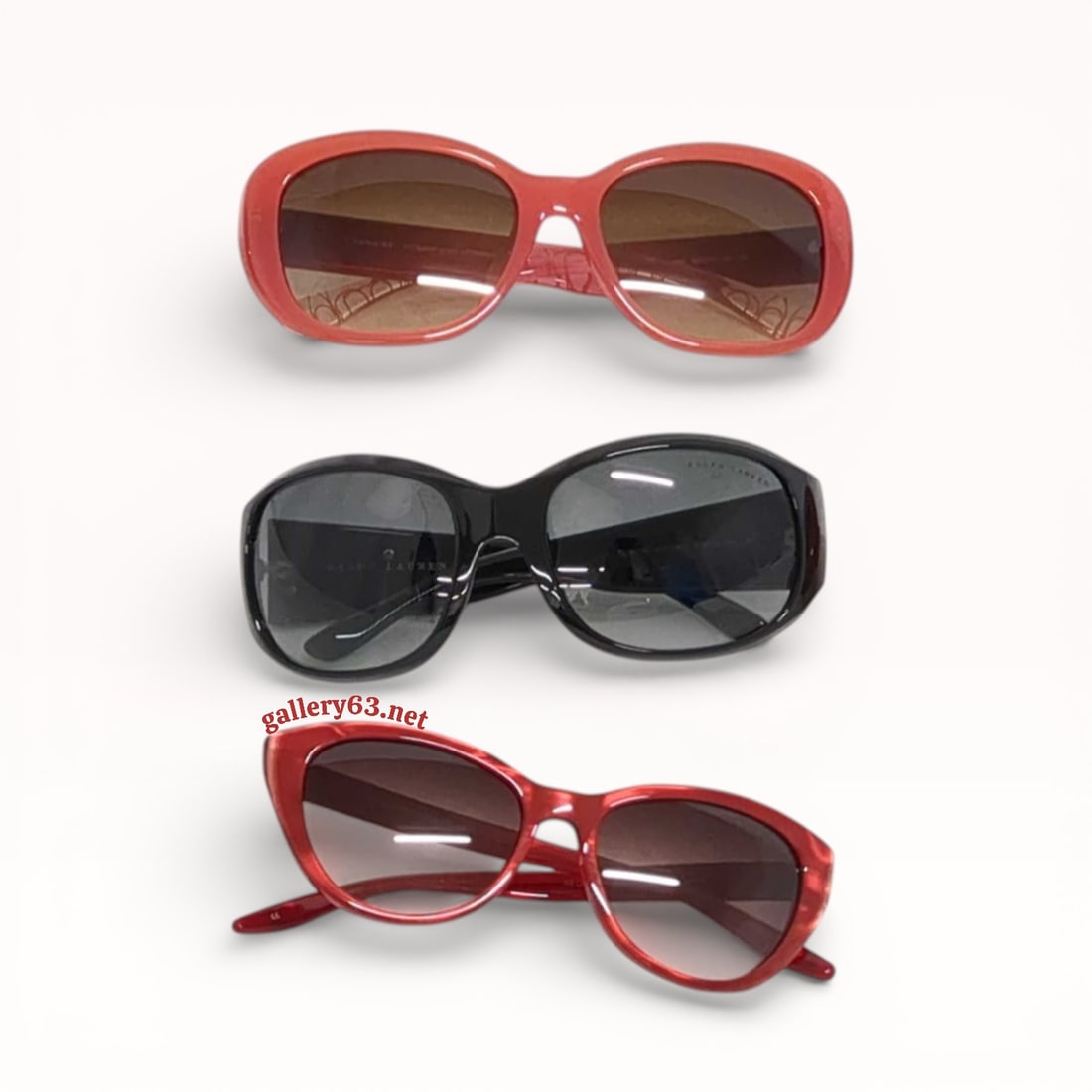 Coach / Ralph Lauren Sunglasses Set: Sunglasses set having three pairs. Assortment featuring oversized plastic frames in red and black colorways. One pair showing Coach branding at the temple. One pair showing Ralph Lauren branding at th