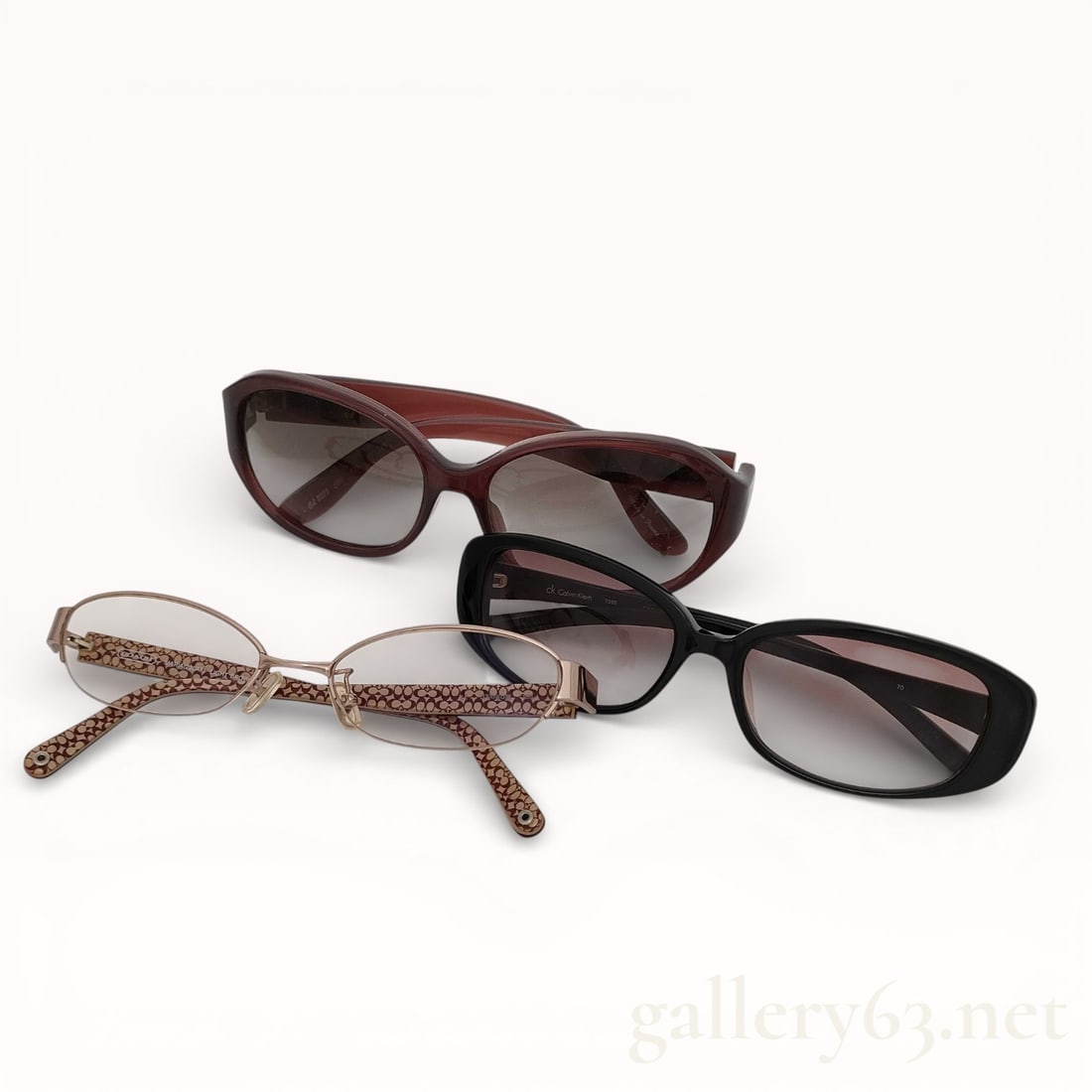 Group of Chloe, Coach, & Calvin Klein Sunglasses: Authentic Sunglasses group set having three assorted pairs. Set including one pair of brown acetate sunglasses with gradient lenses, one pair of black acetate sunglasses with gradient lenses, and one