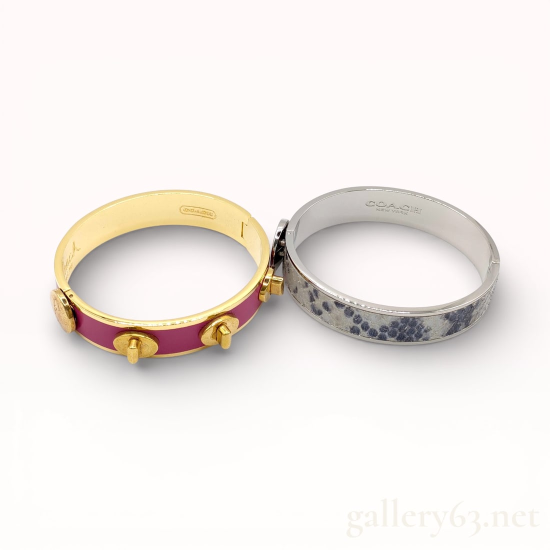 Coach Enamel & Snakeskin Bangle Bracelets Set of Two – Authentic: Coach bangle bracelet set consisting of two hinged bangles. One bangle having a gold-tone metal frame set with pink enamel panels and raised stud accents. Second bangle having a silver-tone metal fram
