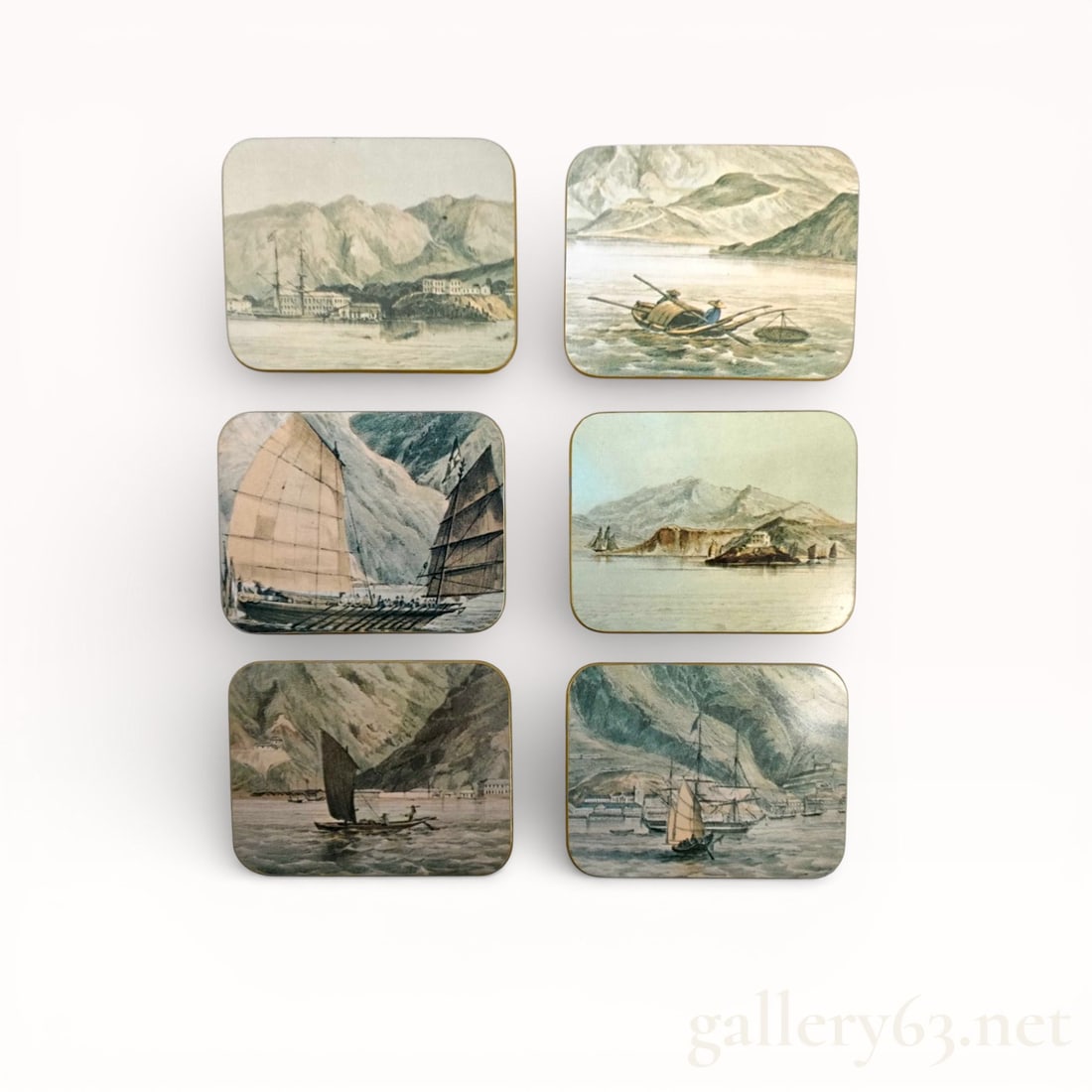 Dunhill Coaster Set with Scenic Motifs: Dunhill coaster set comprising six square coasters featuring printed scenic landscapes with boats and mountainous coastal views. Each coaster having rounded corners and a rigid backing. Reverse sides