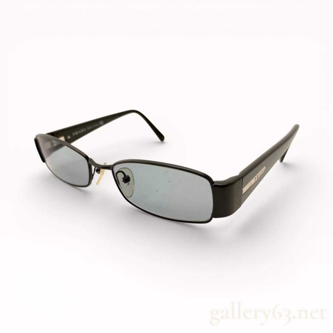 Prada Side-Logo Rectangular Sunglasses: Authentic Prada sunglasses featuring narrow rectangular lenses set in a slim metal frame. Matte-finish temples displaying an applied Prada side logo plaque. Adjustable nose pads and gently curved arms