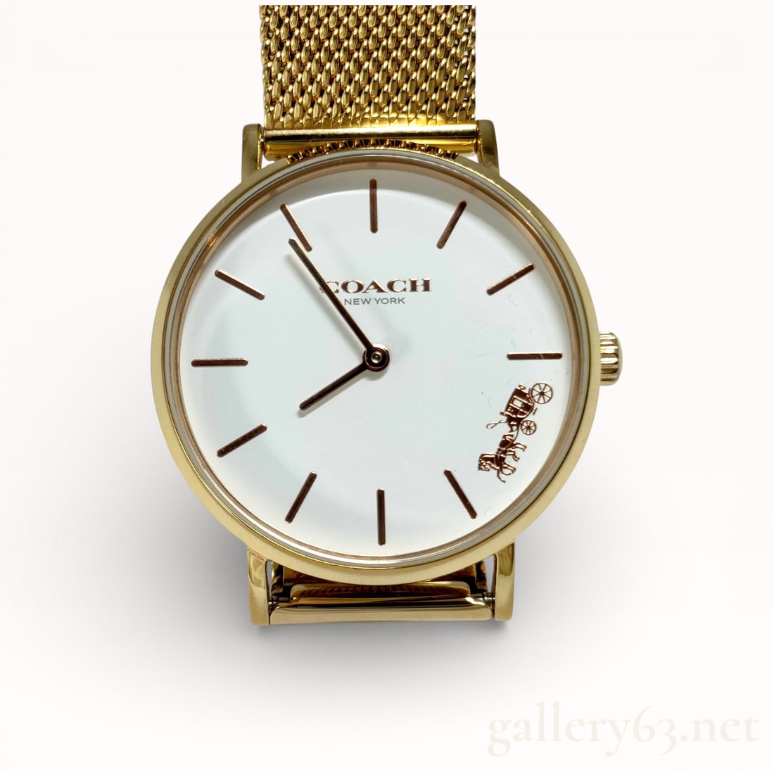 Coach Gold-Tone Mesh Bracelet Ladies Quartz Watch 32mm: Authentic Coach ladies wristwatch featuring a gold-tone round case set with a clean white dial. Dial presenting applied baton hour markers, central hands, and Coach New York branding with signature mo