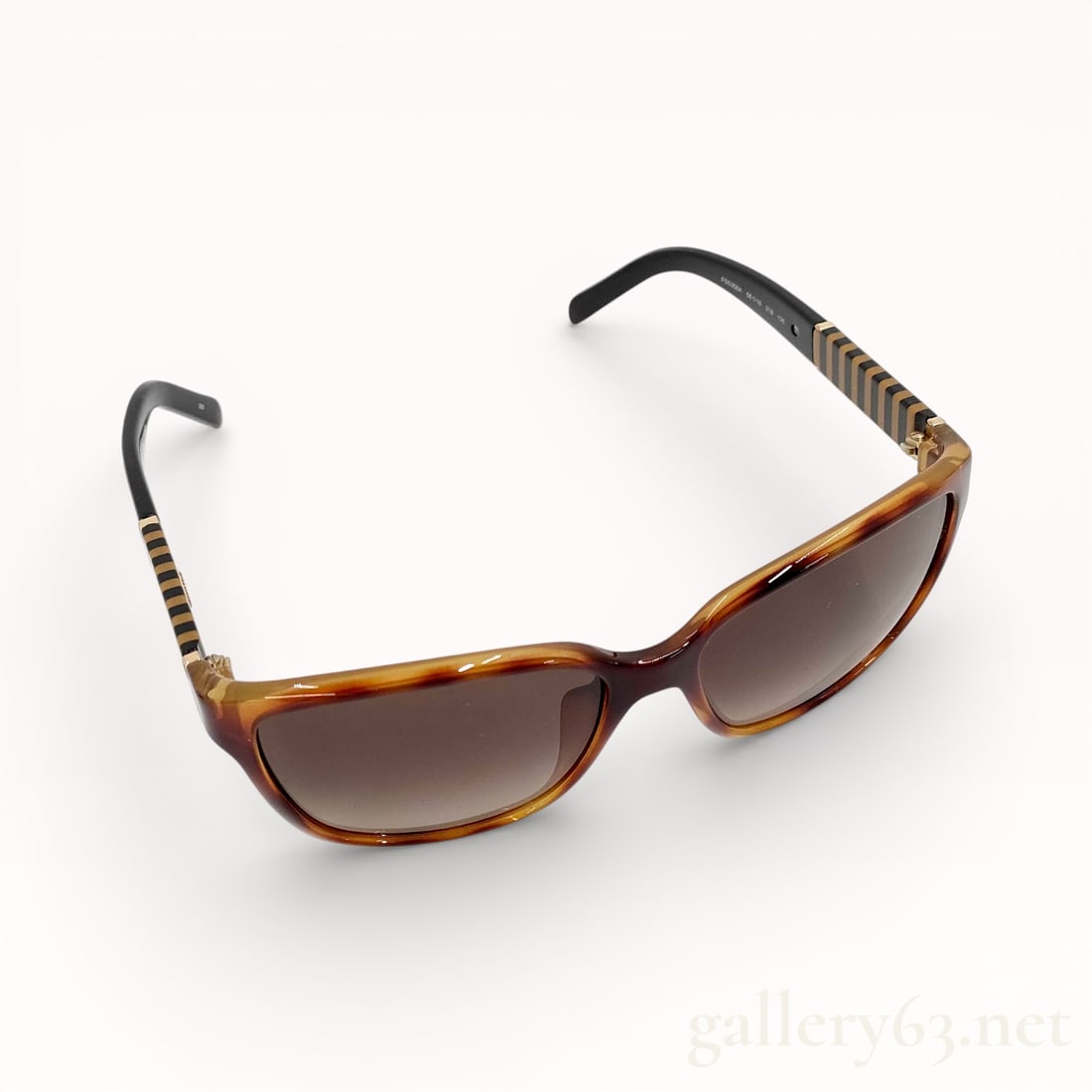 Vintage Fendi Penguin Sunglasses with Case: Authentic vintage pair of Fendi Pequin striped-temple sunglasses in a brown tortoiseshell acetate with gradient lenses. Comes with pouch. 