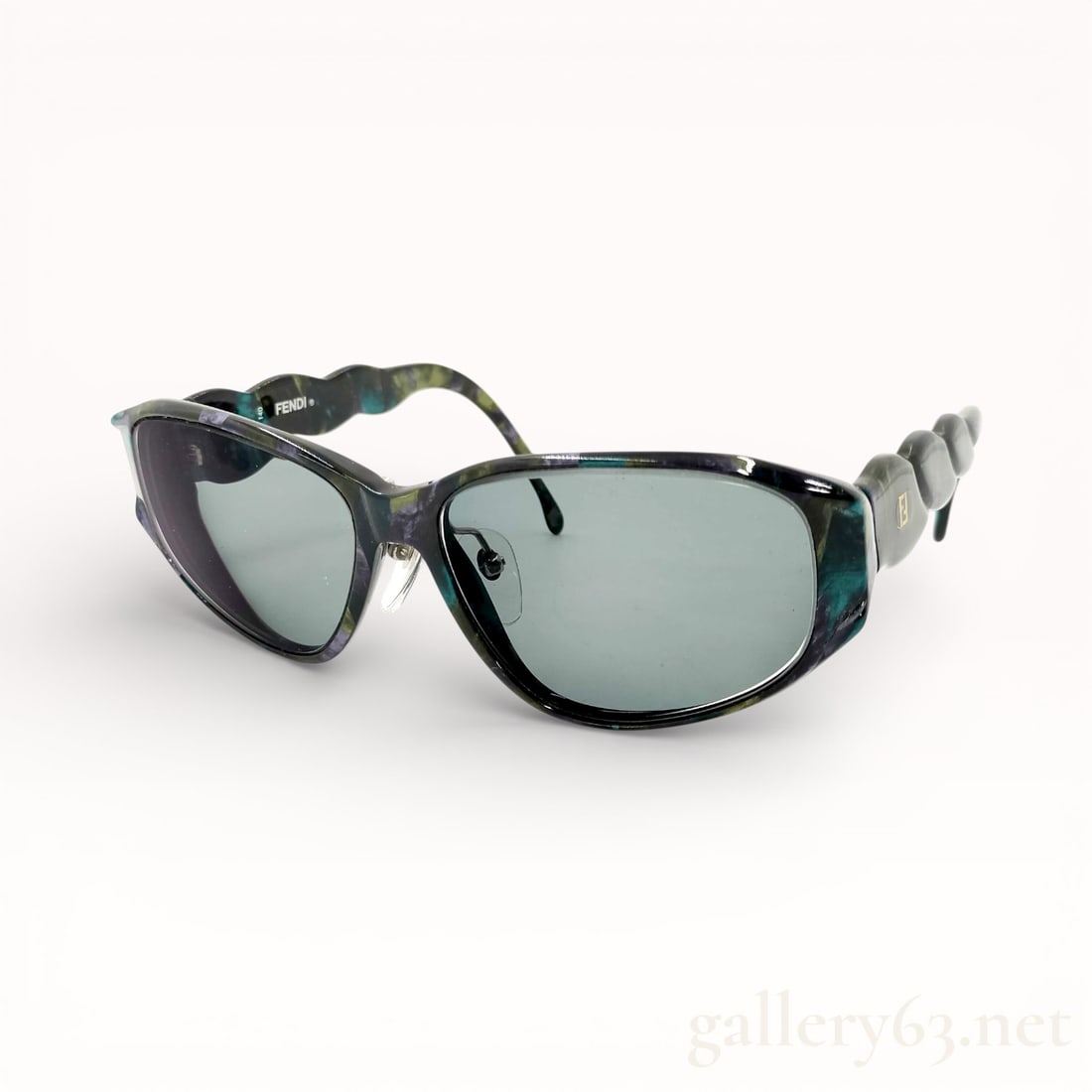 Rare Vintage Fendi FS 102 Swirled Acetate Sunglasses: Vintage Fendi sunglasses featuring wrap-style lenses set in a sculptural acetate frame. Frame displaying a swirled mix of purple, black, and green tones creating a marbled effect. Dark-tinted lenses p