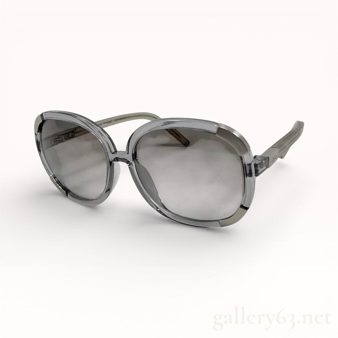 Chloe Oversized Gray Sunglasses: Authentic Chloé sunglasses featuring an oversized translucent gray plastic frame with a softly rounded square lens shape. Gray gradient lenses set within a thick molded front. Temples extending in a