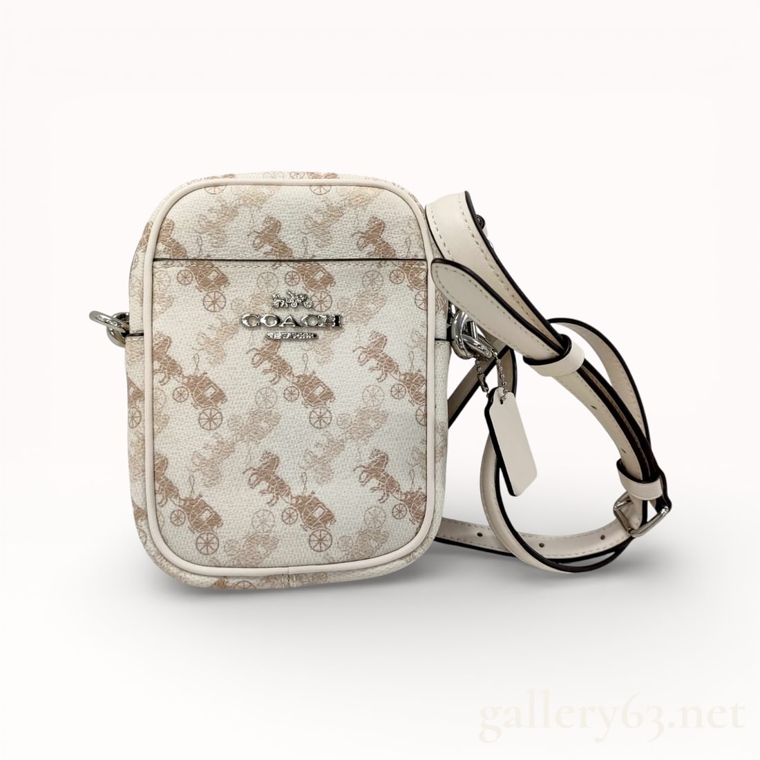 Coach Signature 91108 Crossbody Shoulder Bag: Authentic Coach shoulder bag having a compact rectangular form constructed in light-toned signature coated canvas featuring a repeating horse and carriage motif. Trim and adjustable shoulder strap