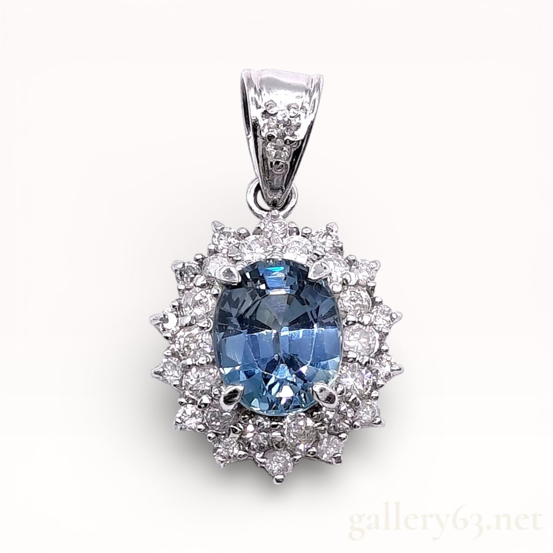 Platinum 2.13ct Sapphire and .57ctw Diamond Double Halo Pendant: Platinum pendant top set with an oval-cut sapphire weighing approximately 2.13 carats, surrounded by round-cut diamond accents totaling approximately 0.57 carat. Pendant featuring a classic