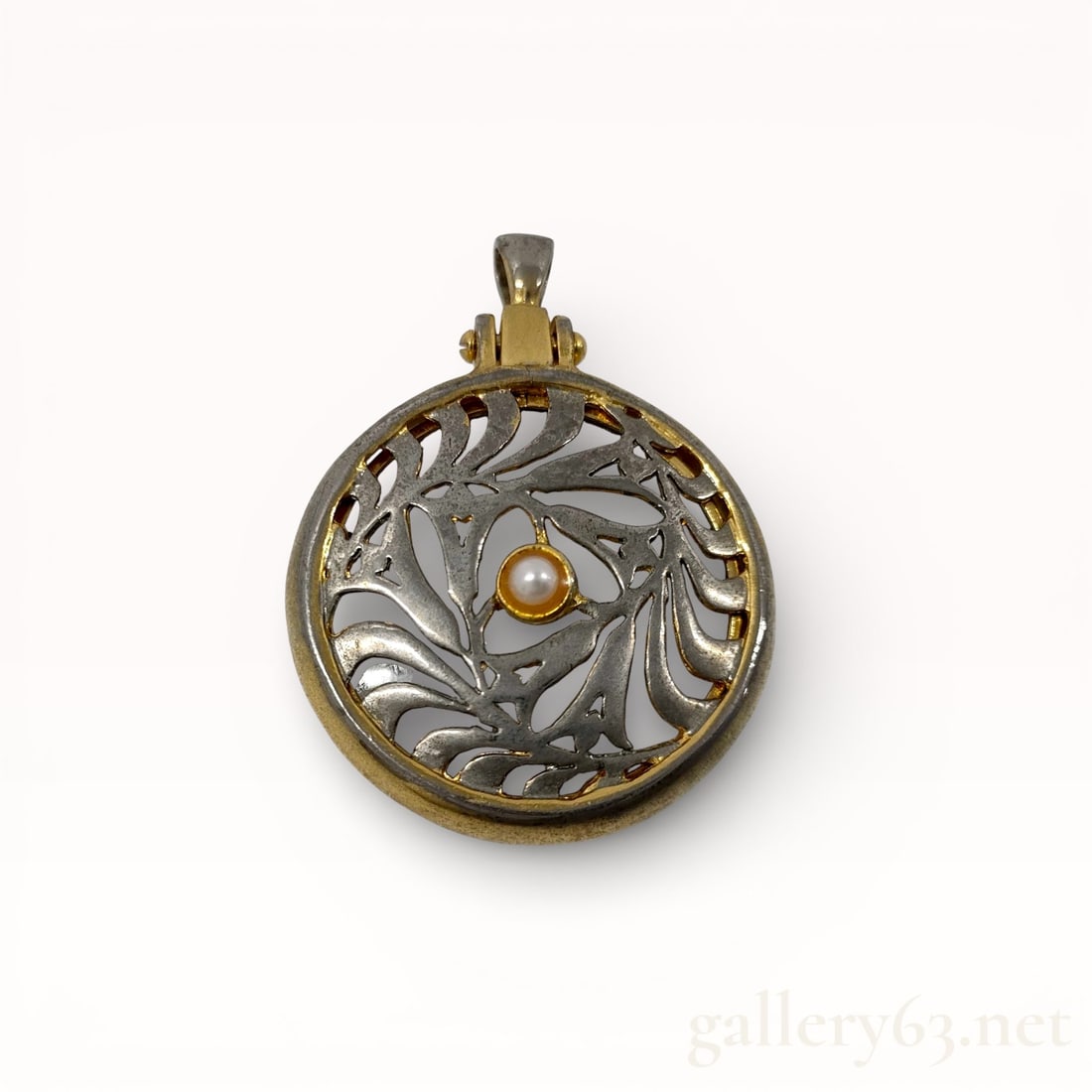 Mikimoto Pearl Pendant Loupe: Authentic Mikimoto pendant loupe featuring a round metal frame with an openwork decorative pattern. Center set with a single pearl mounted in a gold-tone bezel accent. Integrated magnifying lens