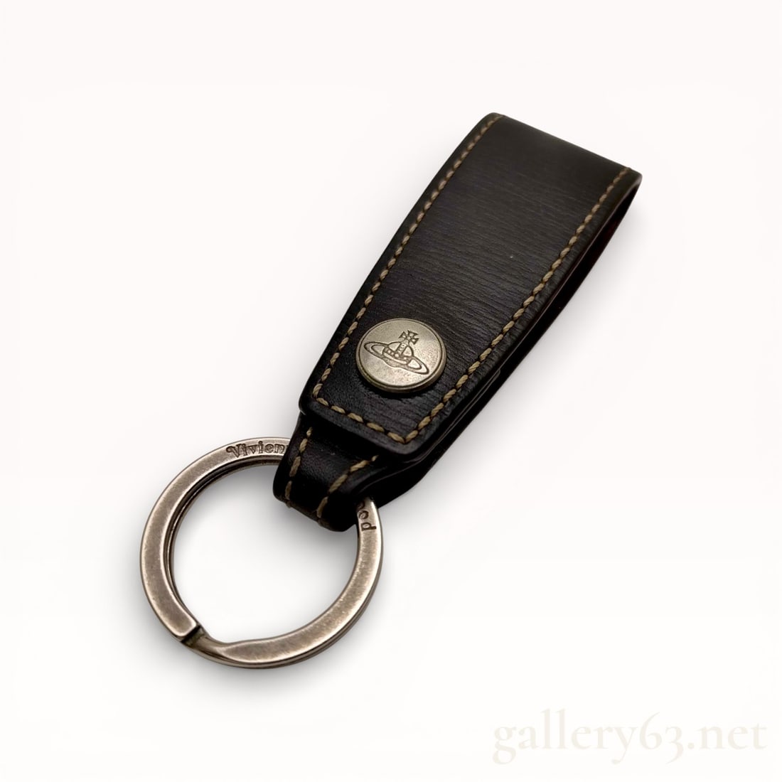 Vivienne Westwood Leather Key Ring with Orb Emblem: Authentic Vivienne Westwood Black leather key ring featuring a folded leather strap with contrast stitching. Silver-tone metal key ring attached at the base. Circular metal stud set at the front,