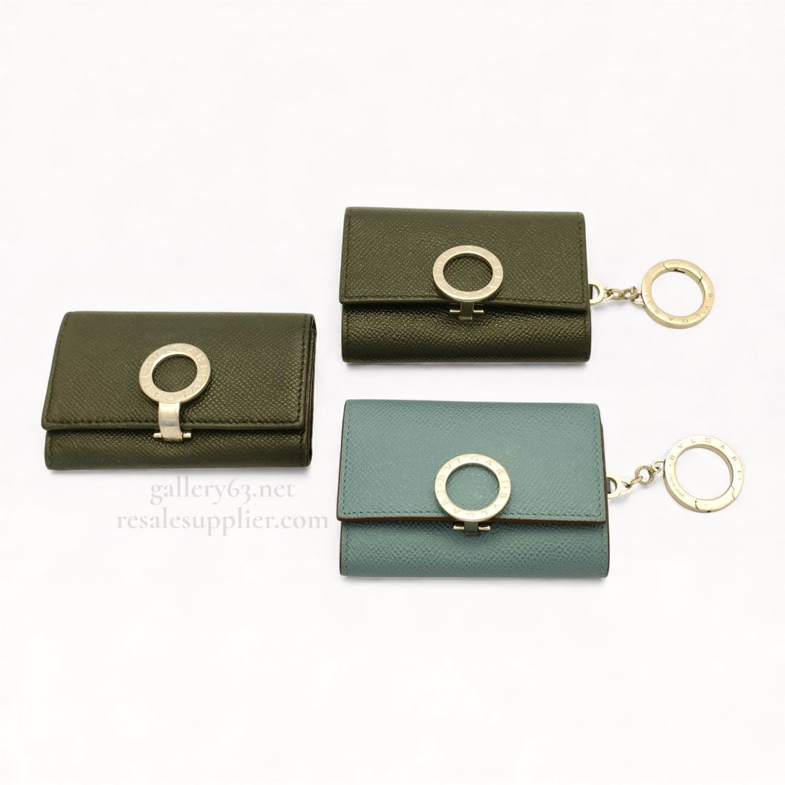 Bvlgari B.zero1 Leather Key Case Set of Three with Key Rings: Bvlgari key case set consisting of three B.zero1–style key holders in textured leather. Cases presented in mixed colors including olive green and muted blue tones. Each case having a flap-front clos