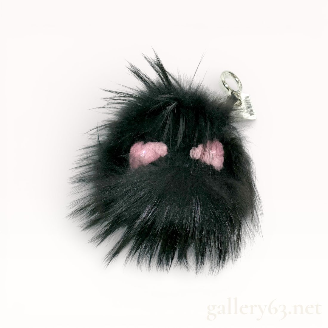Fendi Strap You Fur Bag Charm Keychain: Fendi bag charm keychain featuring a black fur pom form. Accented with pink embroidered facial details set into the fur surface. Finished with a leather strap and silver-tone ring hardware for attachm