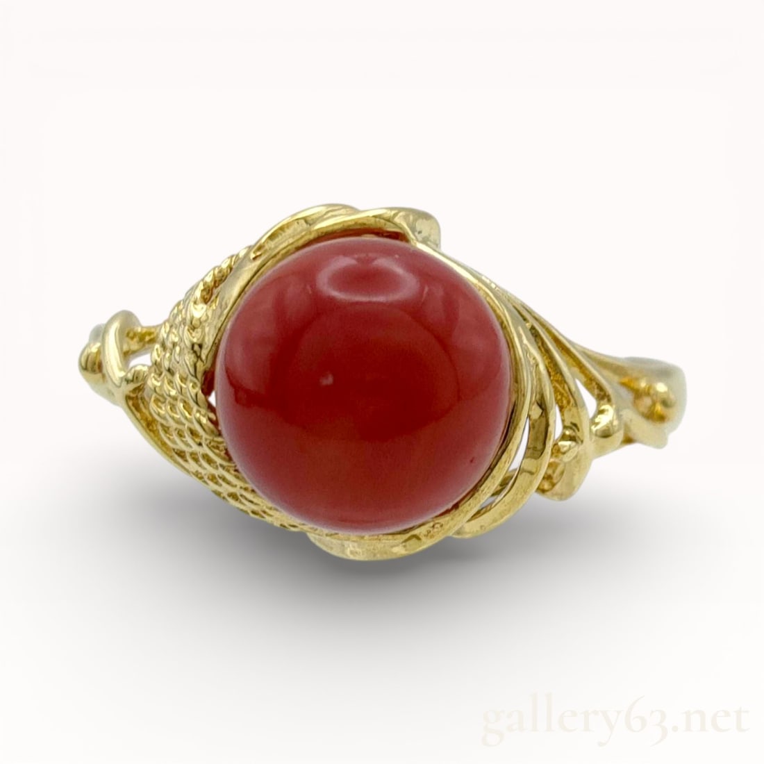 Antique 8mm Coral Ring in 18k Yellow Gold, Size 7: 18k yellow gold ring having an 8mm round coral cabochon center stone. Coral presented in a deep red tone with smooth polished dome. Stone set within an ornate gold mounting featuring openwork and