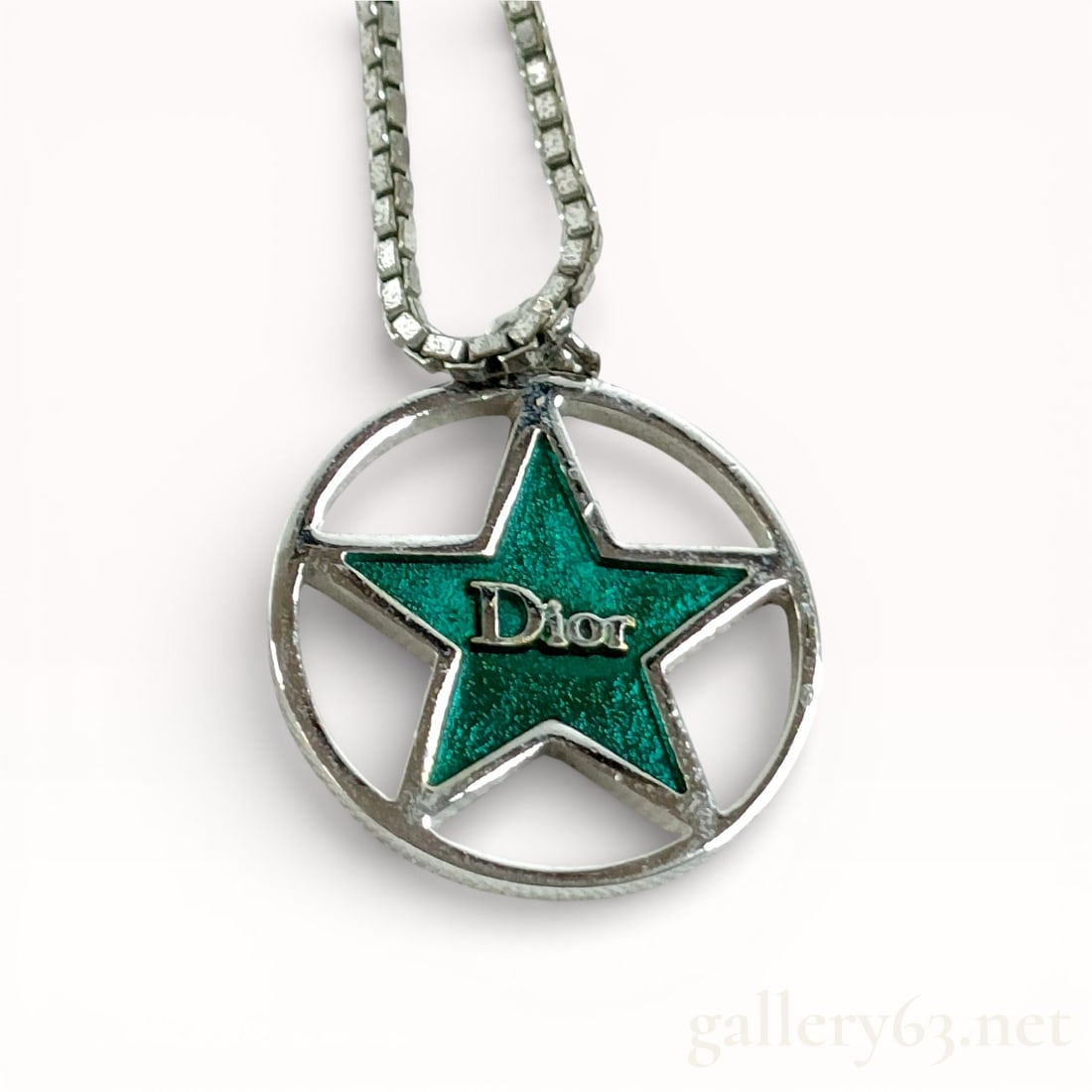 Vintage 1990s Christian Dior Star Logo Pendant Necklace with Lagoon Green Metallic Enamel: Authentic Dior Star Logo Pendant Necklace Catalog description Dior necklace featuring a silver-tone chain suspending a circular openwork pendant. Center set with a five-point star
