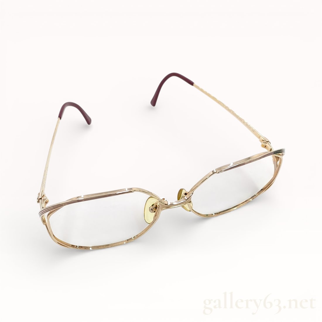 Dior Gold-Tone Metal Frame Eyeglasses: Authentic Dior eyeglasses featuring a gold-tone metal frame with a slim rectangular lens shape. Clear lenses set within fine wire rims. Adjustable clear nose pads mounted on articulated metal arms. Te