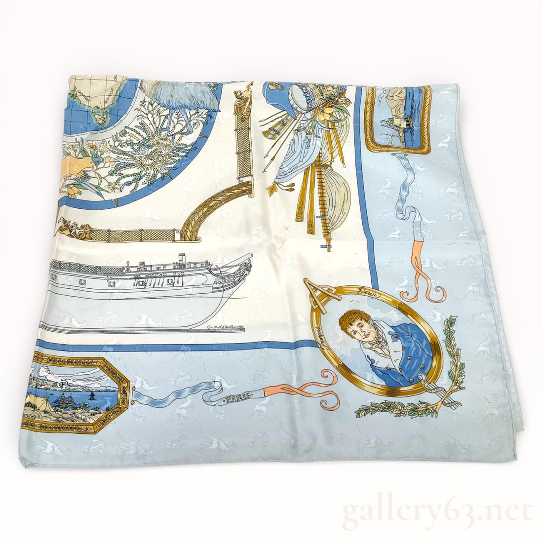 Hermès Le Géographe Silk Carré Scarf 90: Hermès silk carré scarf featuring the Le Géographe design, printed in shades of pale blue, cream, gold, and navy. Design presents maritime and cartographic motifs including a sailing vessel,