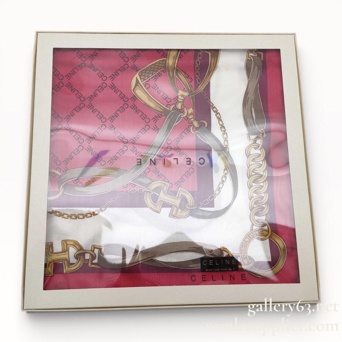 Celine 45cm Scarf with Box: Celine 45x45cm scarf featuring a square format and a printed chain and strap motif. Fabric showing a red and pink ground with gold, brown, and cream accents arranged in a geometric border layout. Celi