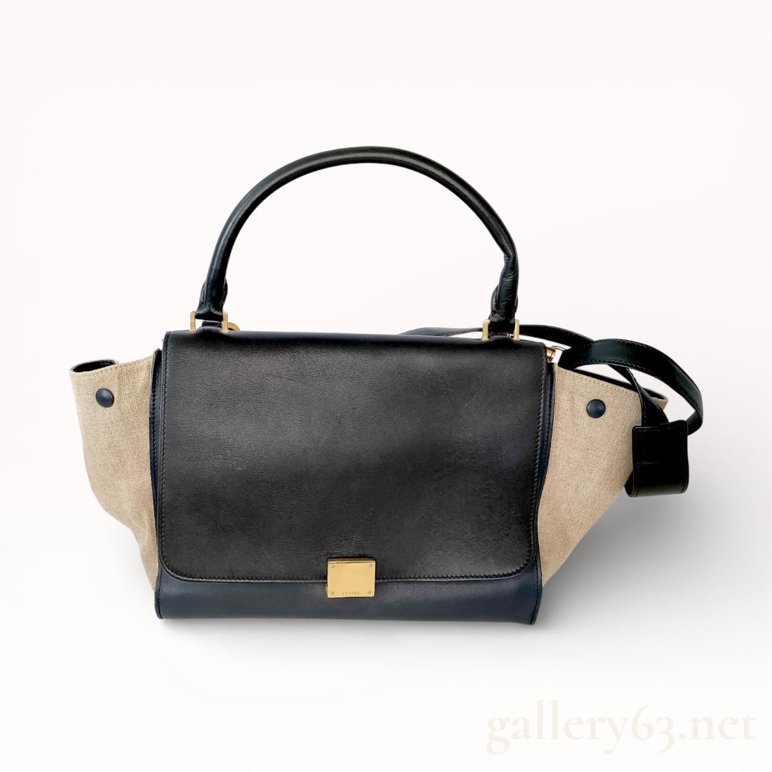 Celine Trapeze Handbag in Black Leather & Taupe Suede: Authentic Celine Trapeze handbag having a black leather front flap and structured body. Featuring contrasting beige side wings extending from the silhouette, each secured with a snap button. Designed