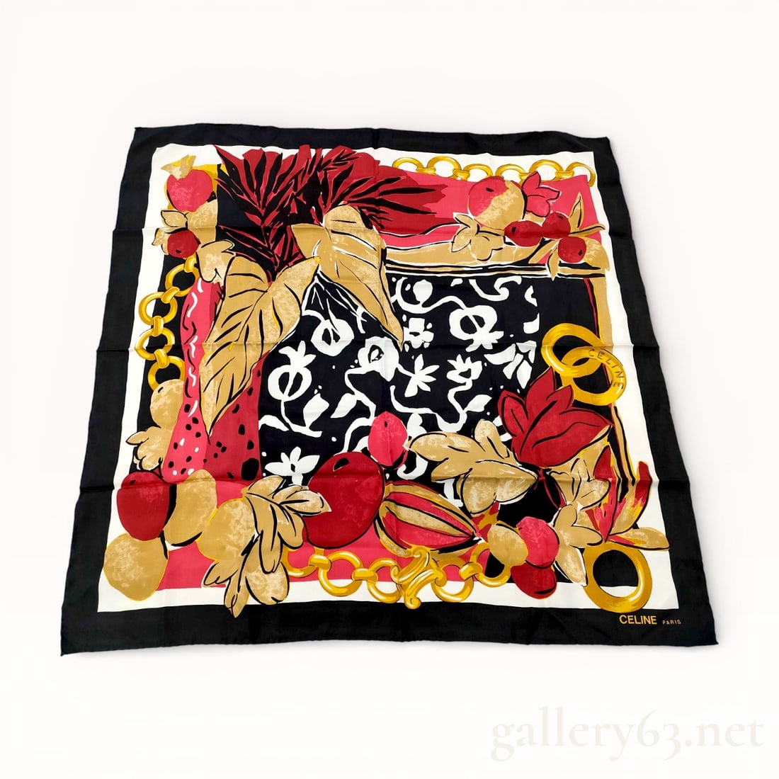 Celine Large Format Silk Scarf: Celine large-format silk scarf featuring a bold graphic composition with abstract floral and foliate motifs, interspersed with chain elements and geometric forms. Palette incorporating red, gold, blac