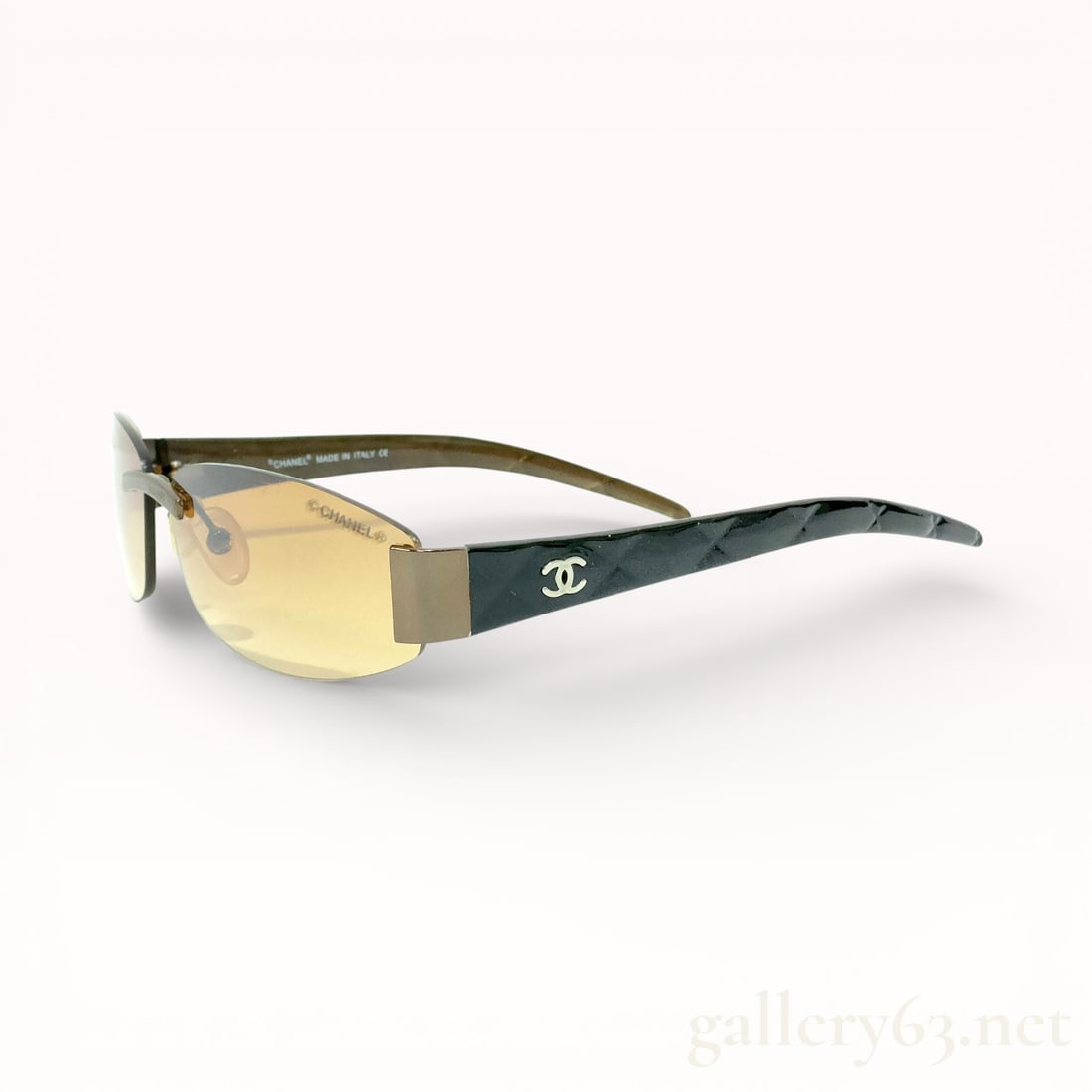 Chanel C.336 Rimless Brown Sunglasses: Authentic Chanel Rimless sunglasses featuring lightly tinted brown lenses with a rectangular silhouette. Slim metal bridge and nose pads supporting the frameless lens design. Black arms having quilted