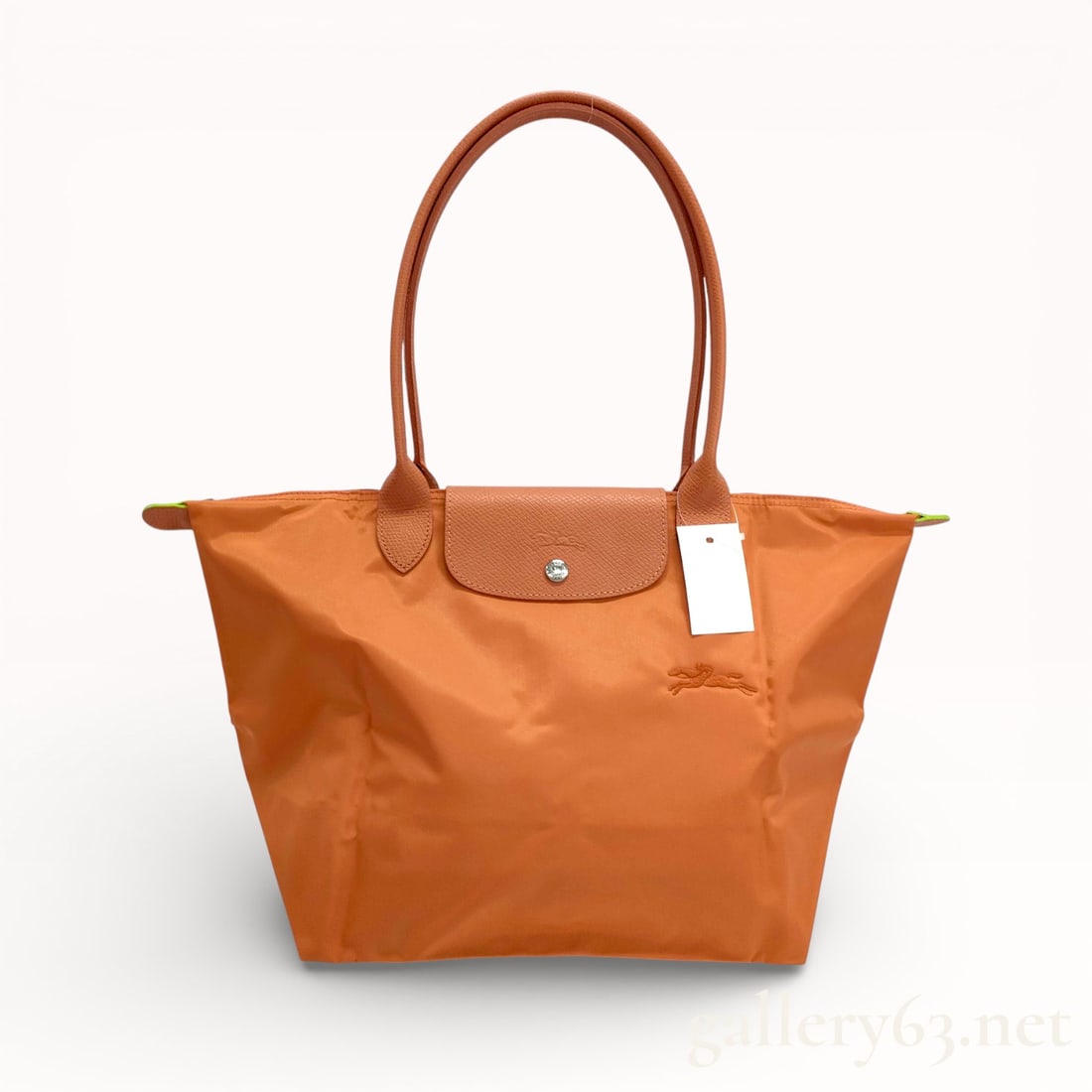 Longchamp Le Pliage Orange Nylon and Leather Tote Bag: Authentic Longchamp Le Pliage orange nylon and leather tote bag with palladium tone hardware. 