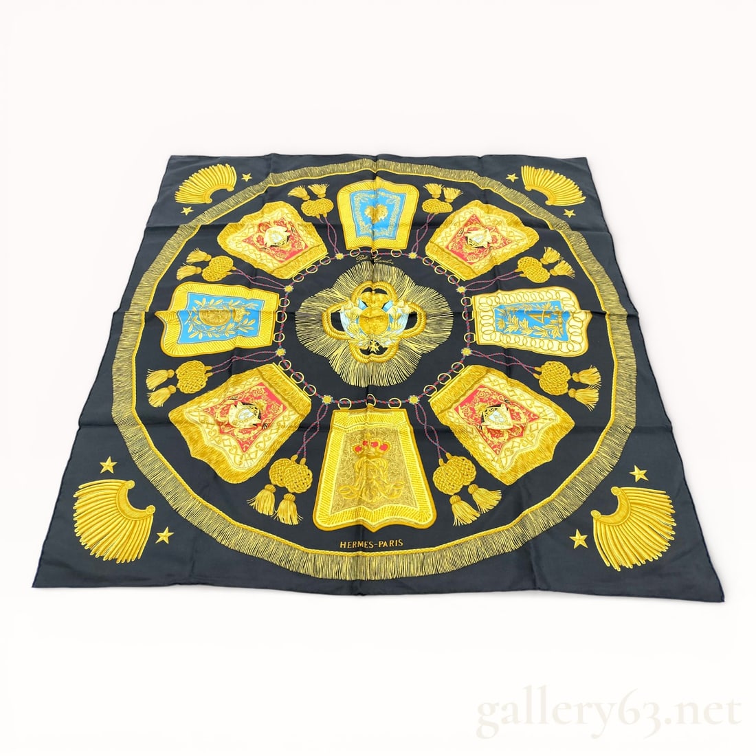 Hermès Poste et Cavalerie Silk Carré Scarf: Hermès silk carré scarf featuring the Poste et Cavalerie design, rendered in black with gold, blue, and red accents. Central circular composition presents heraldic and military motifs including