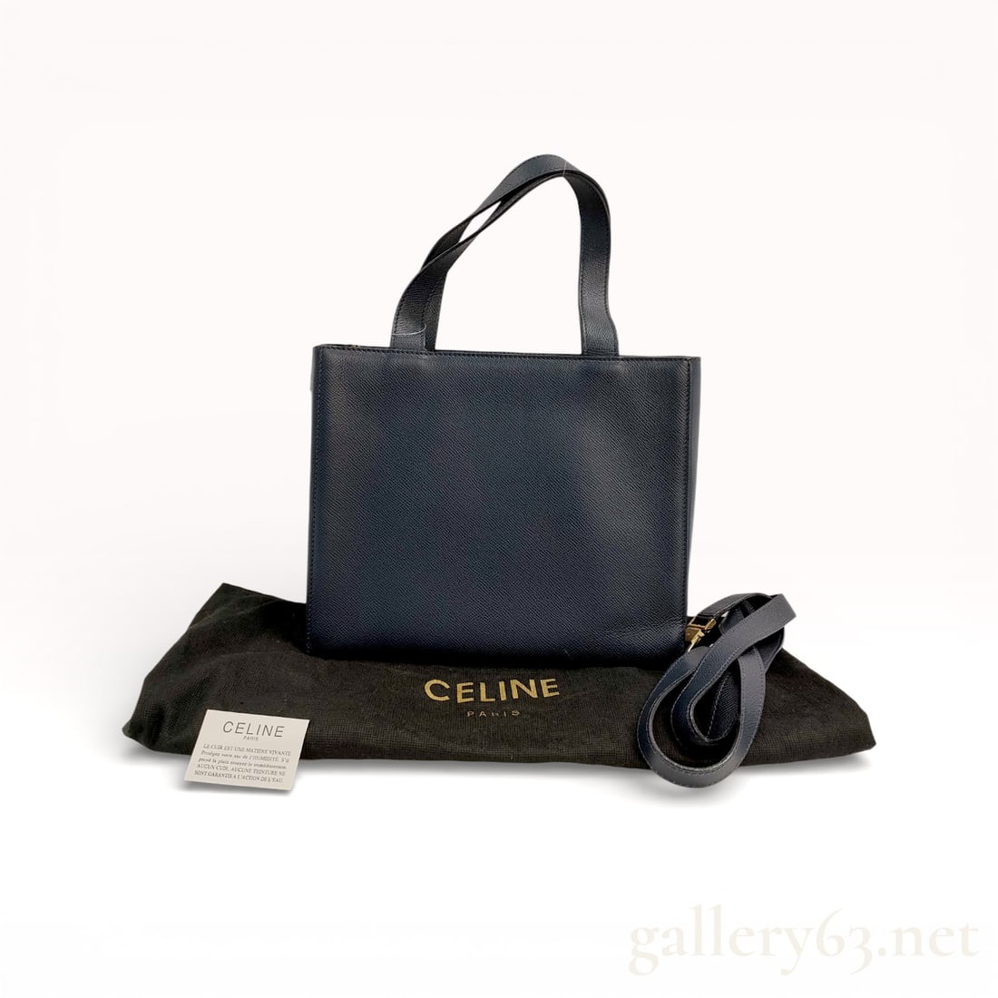 Celine Cabas Phantom 2-Way Handbag in Midnight Blue: Celine leather bag having a structured rectangular silhouette in dark navy leather. Design featuring a single top handle and a detachable leather shoulder strap allowing hand or shoulder carry. Exteri