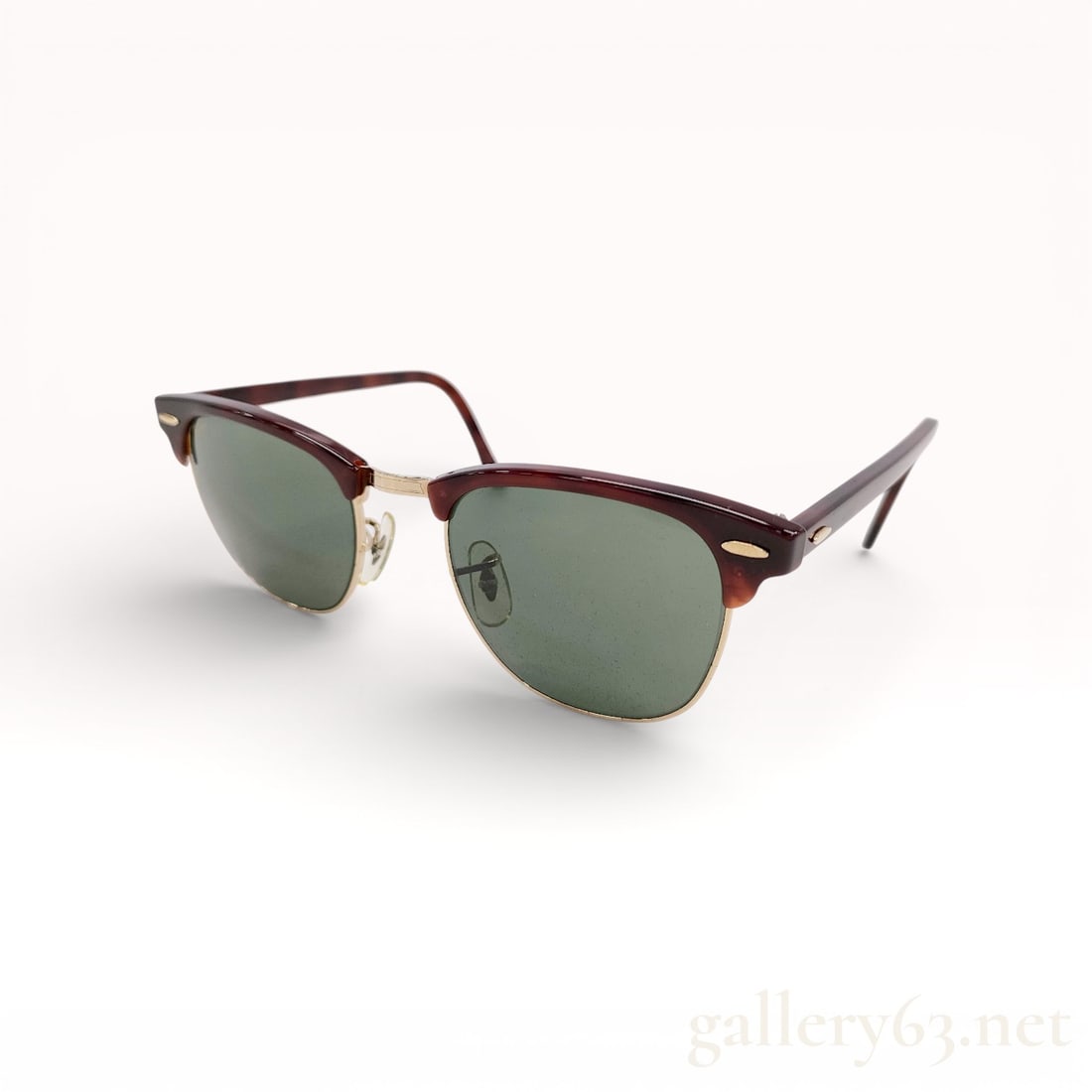 Ray-Ban Bausch & Lomb Sunglasses: Ray-Ban sunglasses featuring green-tinted lenses set within a browline-style frame. Upper frame portion in dark acetate with metal lower rims and bridge. Adjustable nose pads and slender temples. Mark