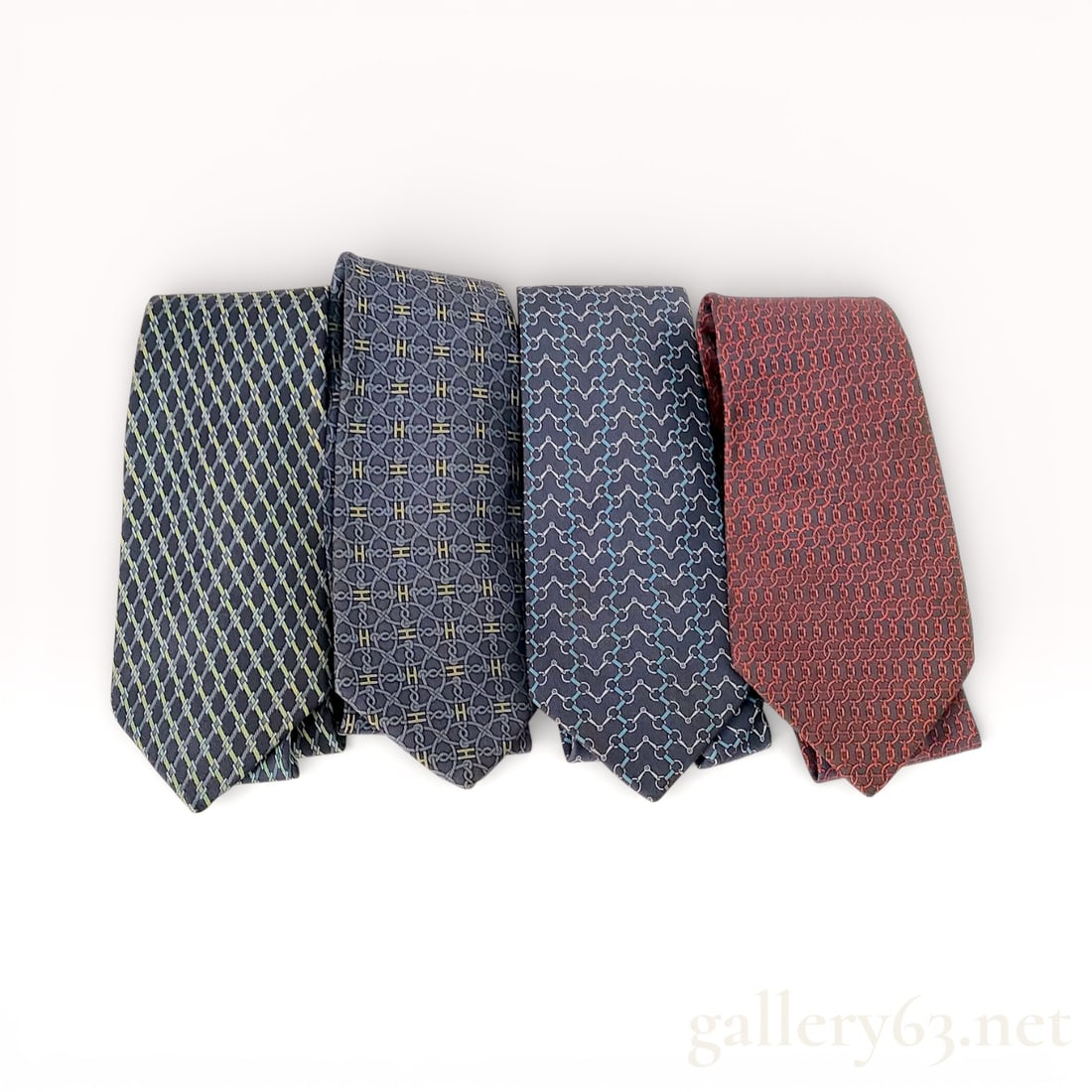 Hermès Silk Tie Group of Four: Authentic Group of four Hermès silk ties, each presenting an all-over woven or printed pattern in varying colorways. Assortment includes geometric and repeating motif designs, reflecting classic Herm