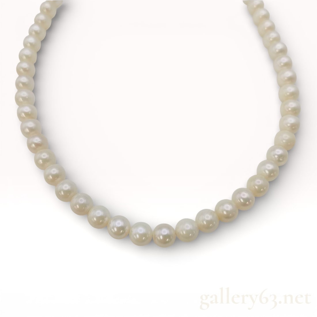 Opera-Length Strand of Cultured Pearls 6.0mm-6.1mm with Silver Clasp: Freshwater pearl necklace strung with uniformly sized round pearls presenting a soft white luster. Pearls measuring approximately 6.0–6.1 mm in diameter. Continuous strand forming a classic, balance