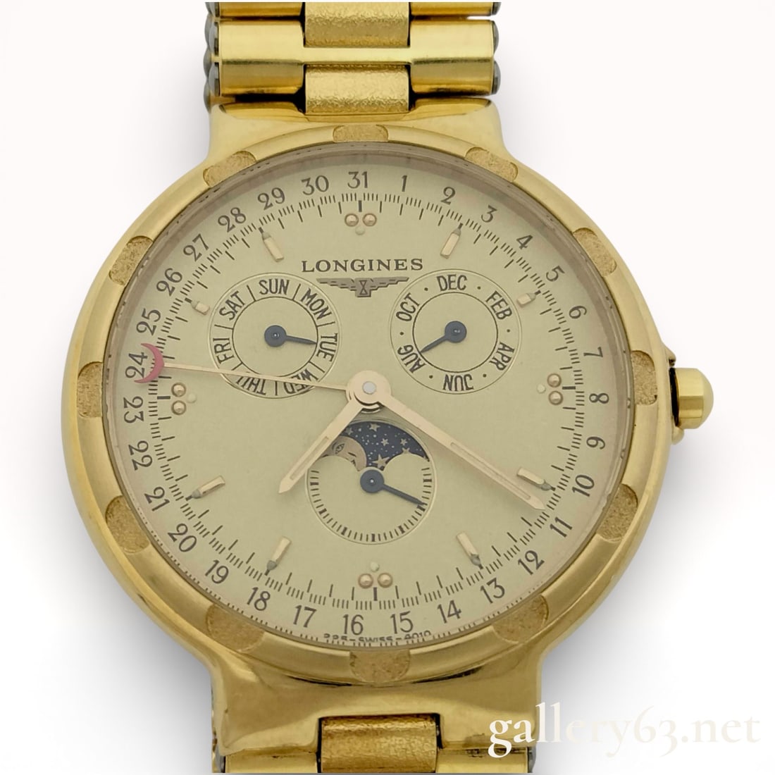 Longines Conquest Moonphase Watch, 32mm: Longines Conquest moonphase wristwatch featuring a round gold-tone case set with a matching bracelet. Dial presenting a multi-register layout with day, date, month, and moonphase complications. Cream-