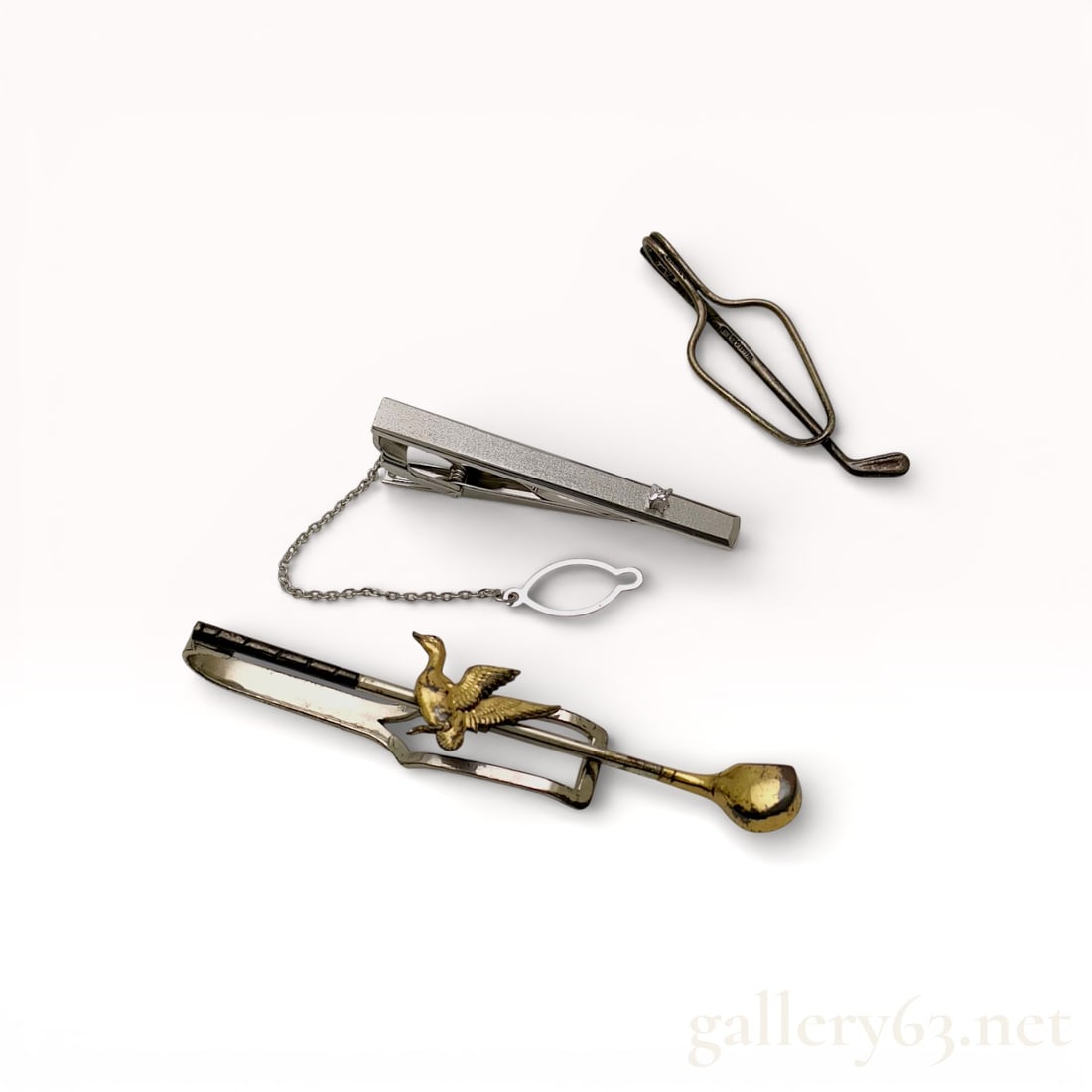 Tiffany & Co. Sterling Silver & Other Brands Tie Accessory Set of 3: Collection of three (3) tie accessories including golf Tiffany tie clip. Designs include linear and sculptural forms with smooth and brushed surfaces. Showing surface wear consistent with use.