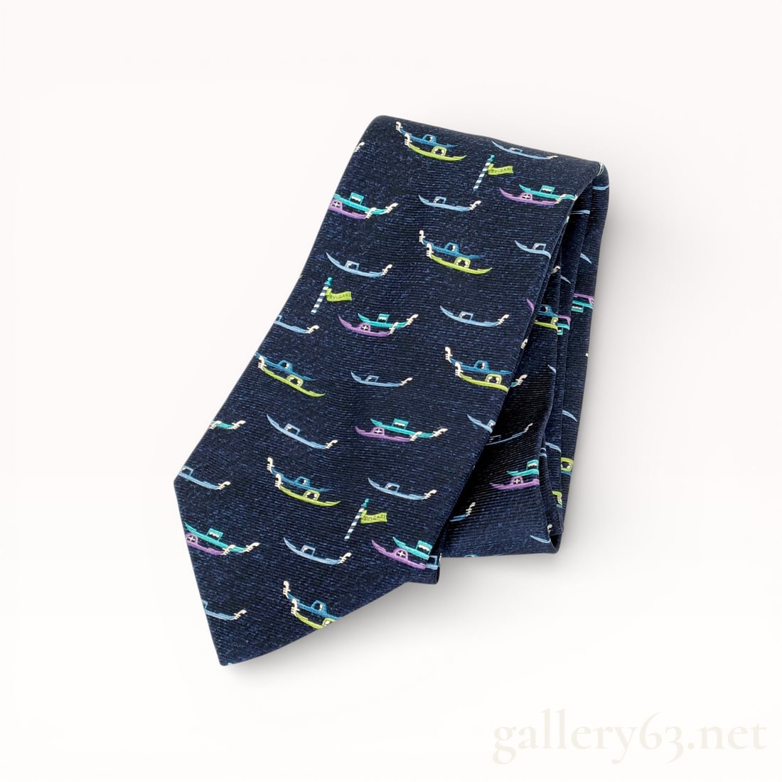 Bvlgari Silk Tie with Boat Pattern: Authentic Bvlgari silk necktie featuring an allover repeating boat motif. Woven design set against a dark navy ground with multicolored accents. Traditional pointed tip construction with coordinated s