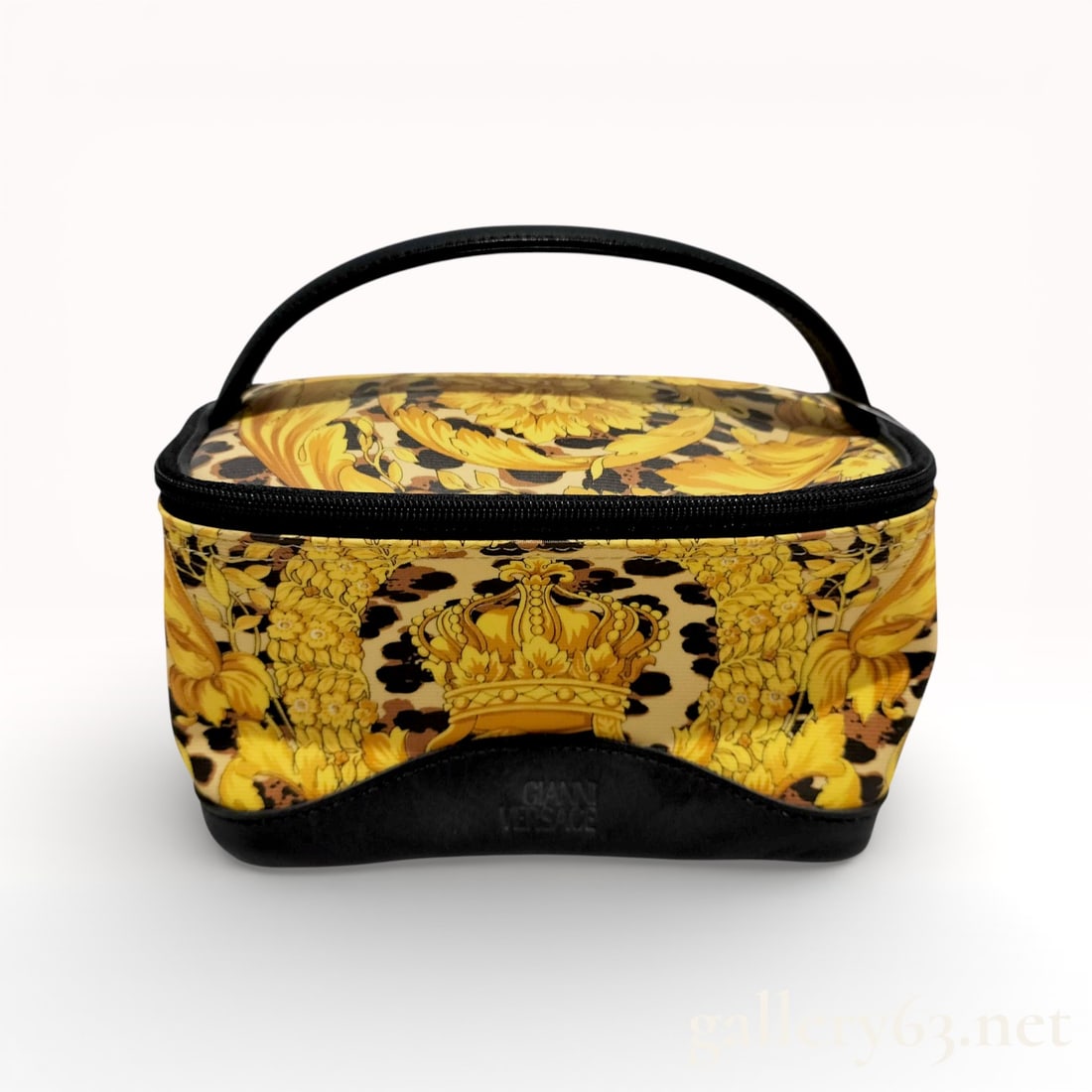 Versace Leopard Cosmetic Pouch: Versace cosmetic pouch having a structured soft case form with a top handle. Exterior featuring a leopard pattern combined with ornate baroque-style motifs in gold and black tones. Zip-around closure
