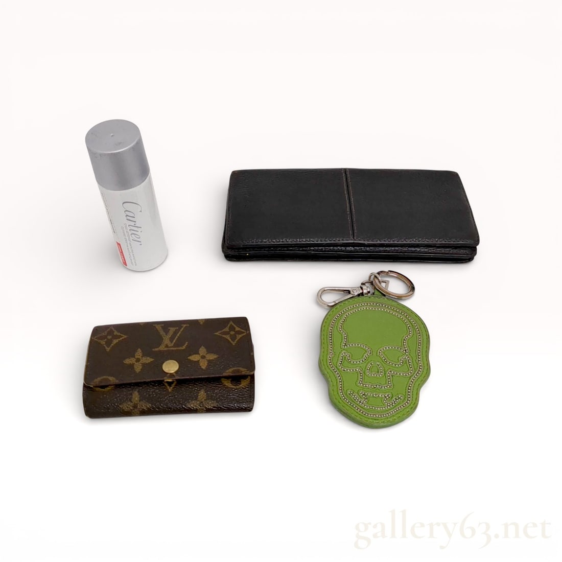 Louis Vuitton and Cartier Leather Accessory Set: Authentic Accessory set including a Louis Vuitton monogram canvas card case, a Cartier black leather wallet, and a Cartier cylindrical accessory container. Set also including a leather key charm featu