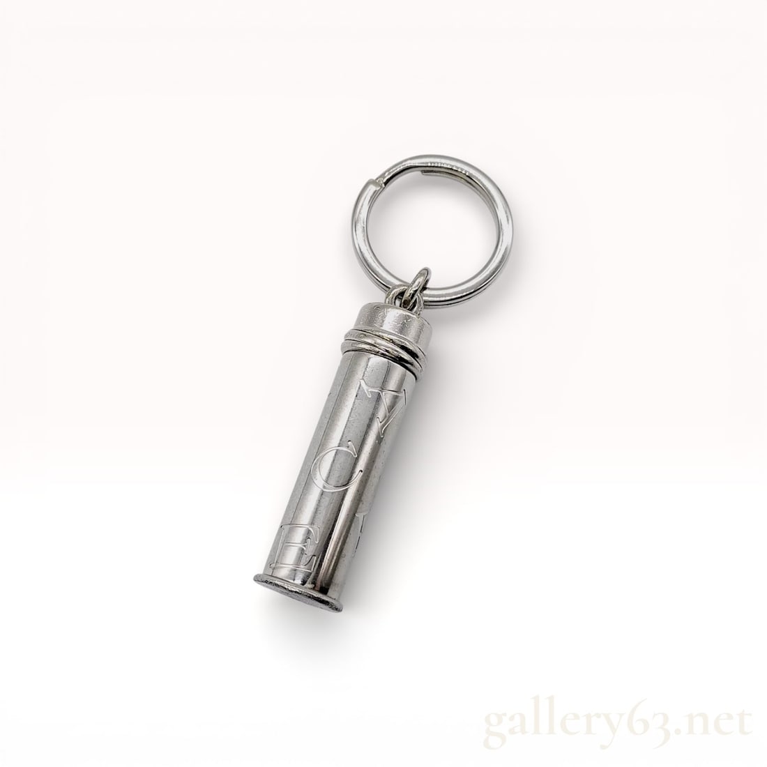 Cartier Sterling Silver Pill Case Charm with Box: Cartier sterling silver pill case charm having a cylindrical form with engraved detailing. Hinged cap opening to a small interior compartment. Attached circular ring allowing suspension from a chain o
