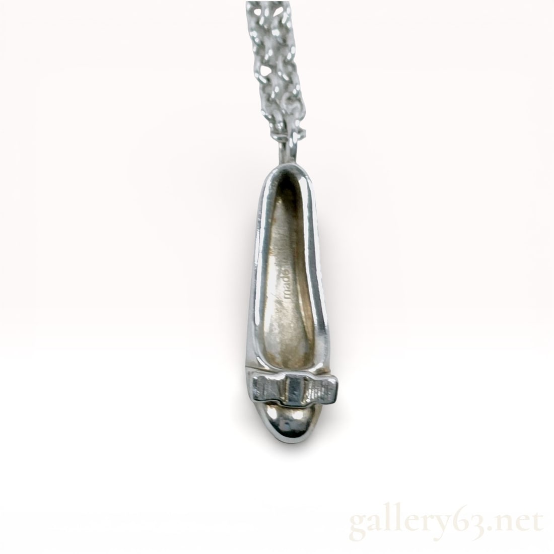 Salvatore Ferragamo Sterling Silver Pumps Motif Necklace: Salvatore Ferragamo sterling silver necklace featuring a sculptural pumps shoe motif pendant with a polished finish. Pendant suspended from a sterling silver chain. Salvatore Ferragamo and silver puri