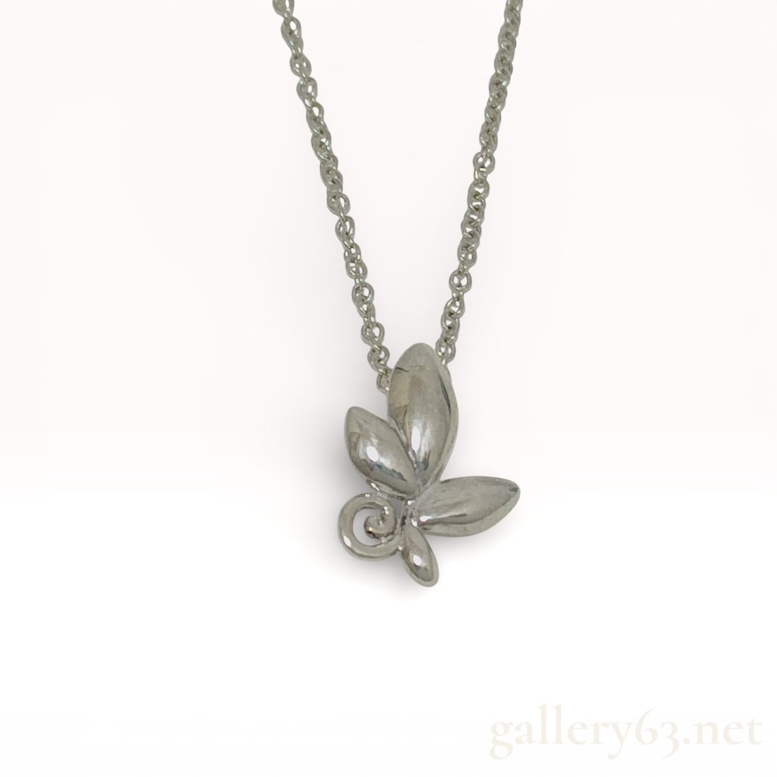 Tiffany & Co. Paloma Picasso Olive Leaf Sterling Silver Necklace: Sterling silver necklace from Tiffany & Co., designed by Paloma Picasso. Pendant formed as an olive leaf motif with polished surfaces and sculptural contours, suspended from a fine link chain. Nec