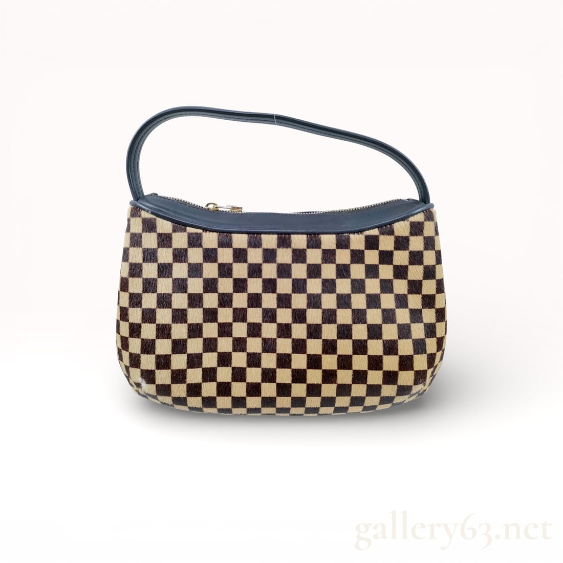Louis Vuitton Damier Sauvage Tiger Haircalf Handbag: Authentic Louis Vuitton Damier Sauvage handbag crafted in tiger-pattern haircalf with black leather trim. Compact top-handle silhouette with zip closure and gold-tone hardware. Bold texture, rare mate